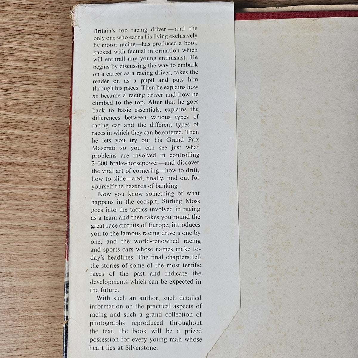 Vintage motor sport hardcover book open to printed text page with paragraphs
