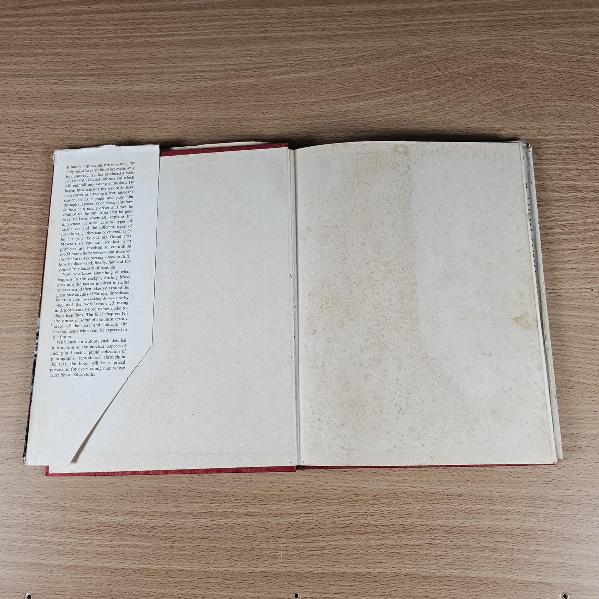 Vintage motor sport hardcover book open to two blankish pages with page edges