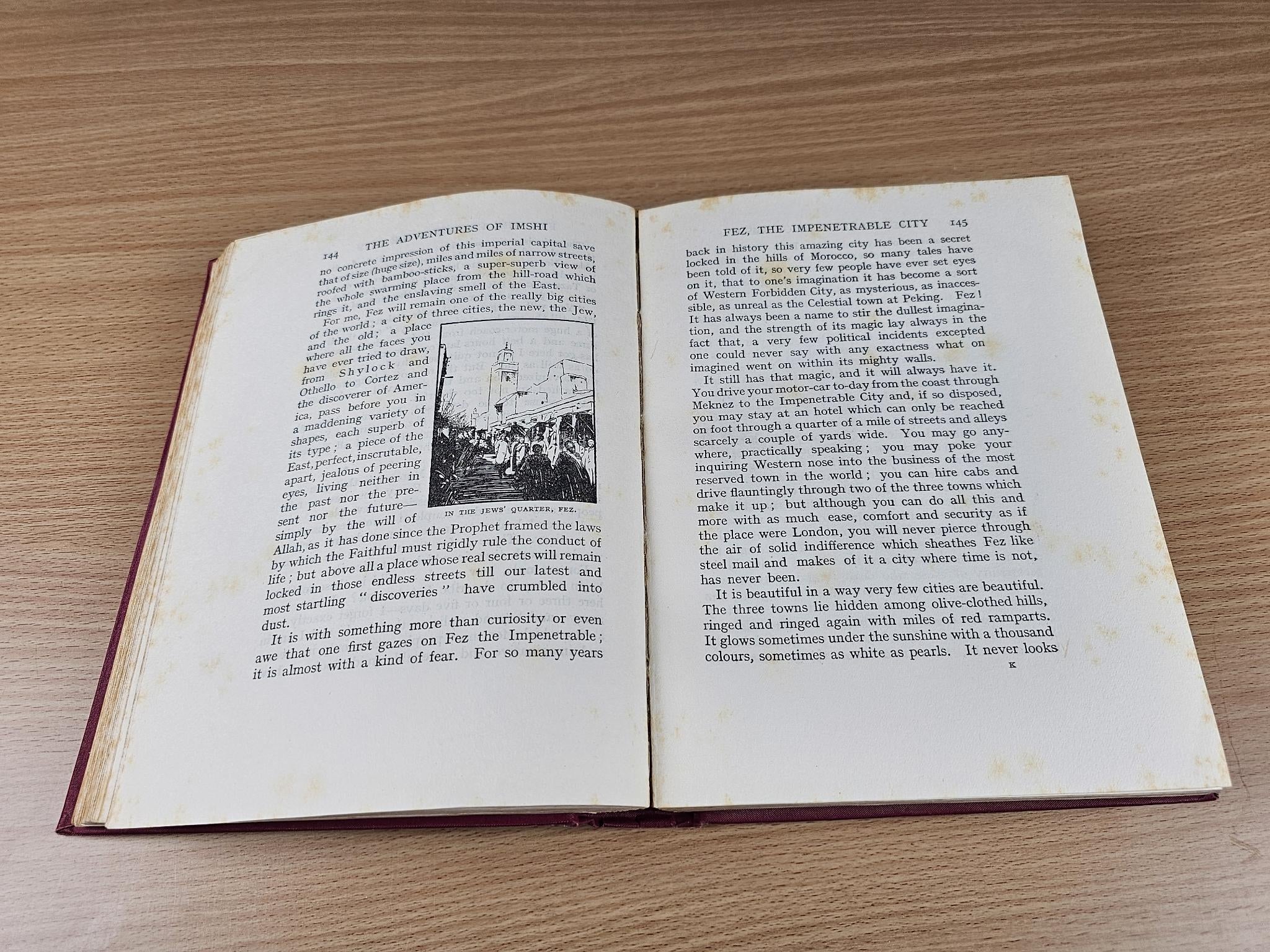 Open book with printed text and a small black-and-white illustration