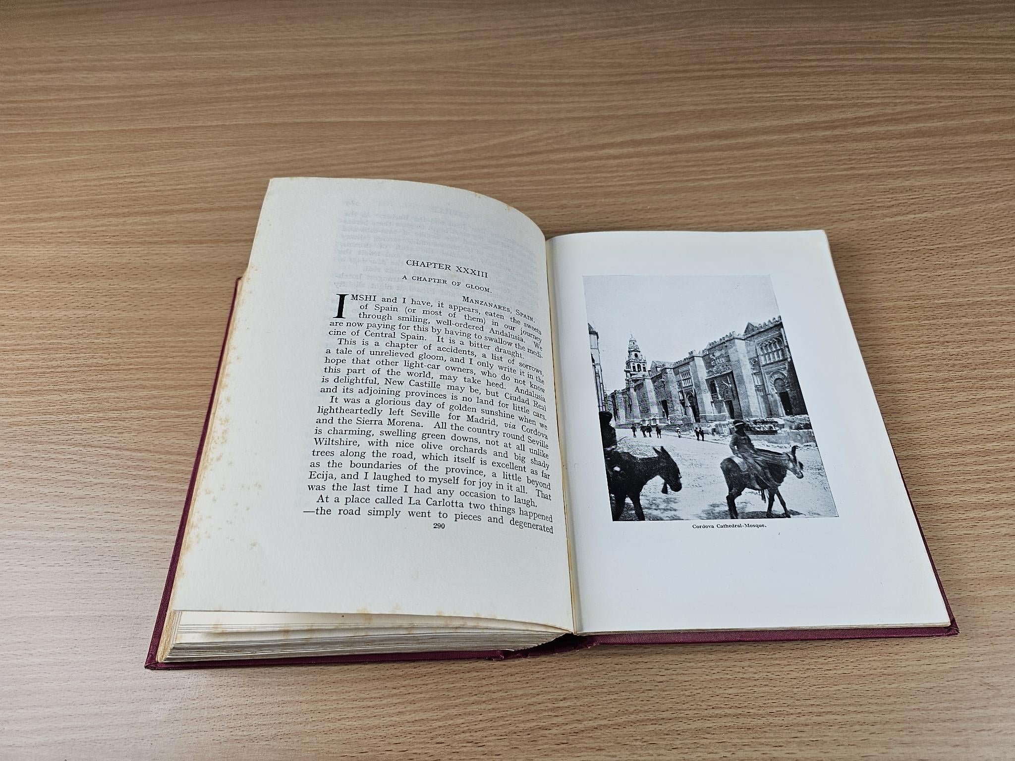 Open book with text and a black-and-white street photo