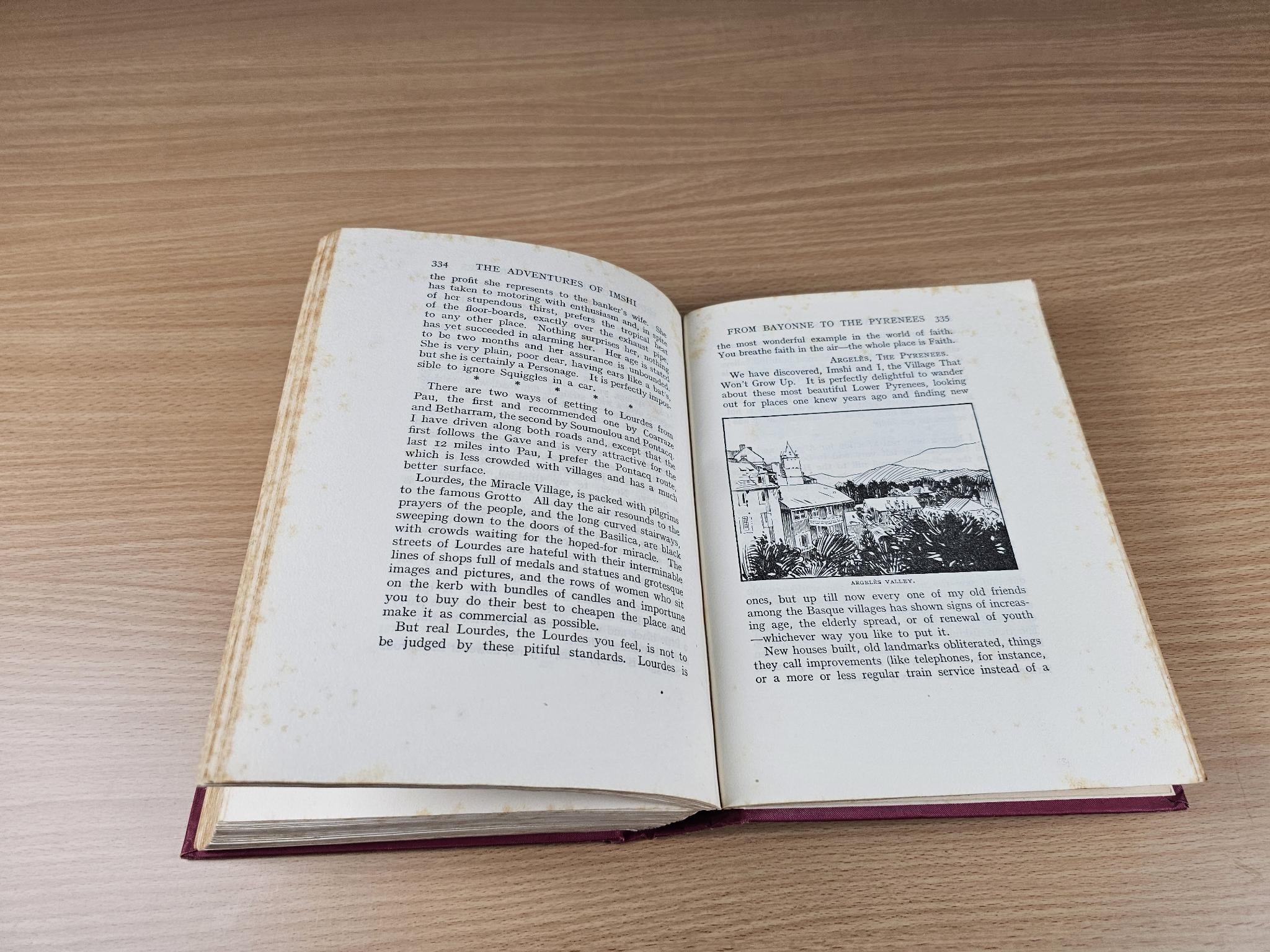 Open book with printed text and a small landscape photo