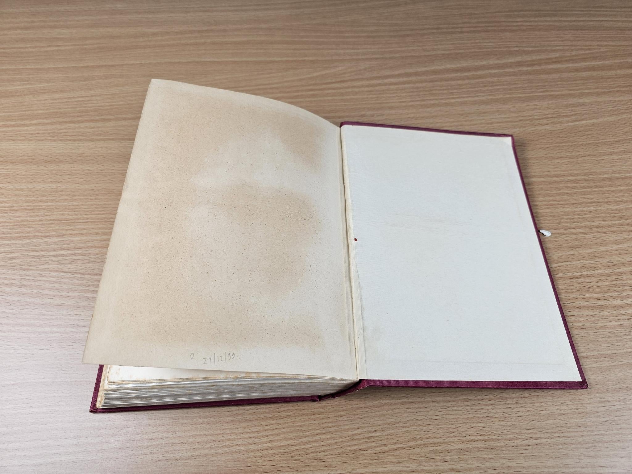 Open book with blank pages, dark maroon cover edge