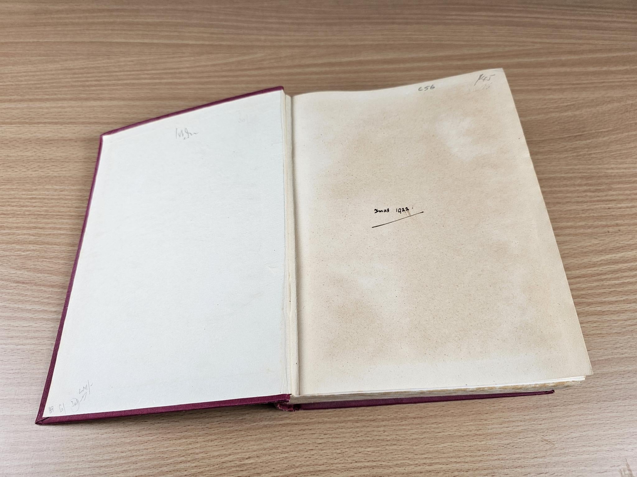 Open book showing blank pages and faint handwritten markings
