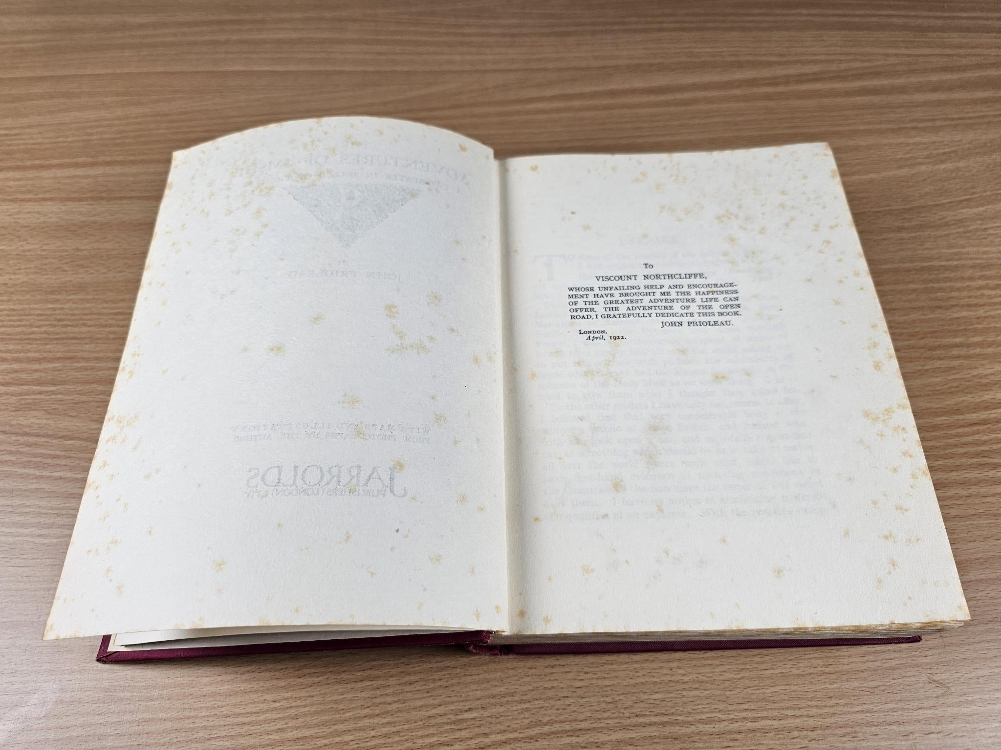 Opened vintage book showing plain text pages with faint discoloration and page headings