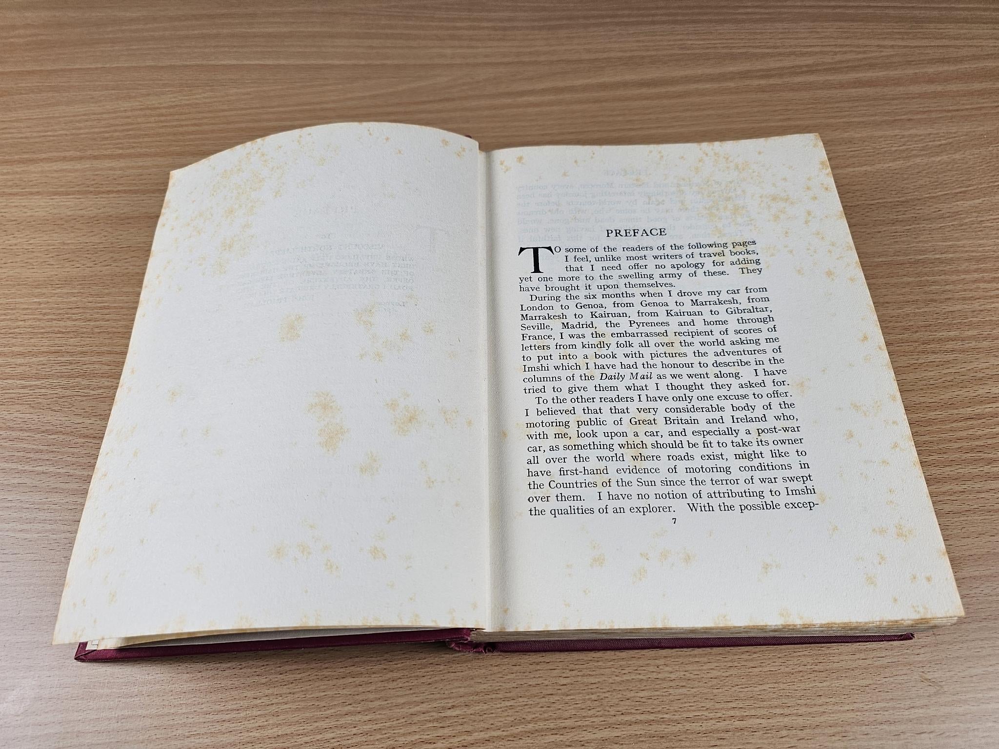 Opened vintage book with printed preface text on the right page