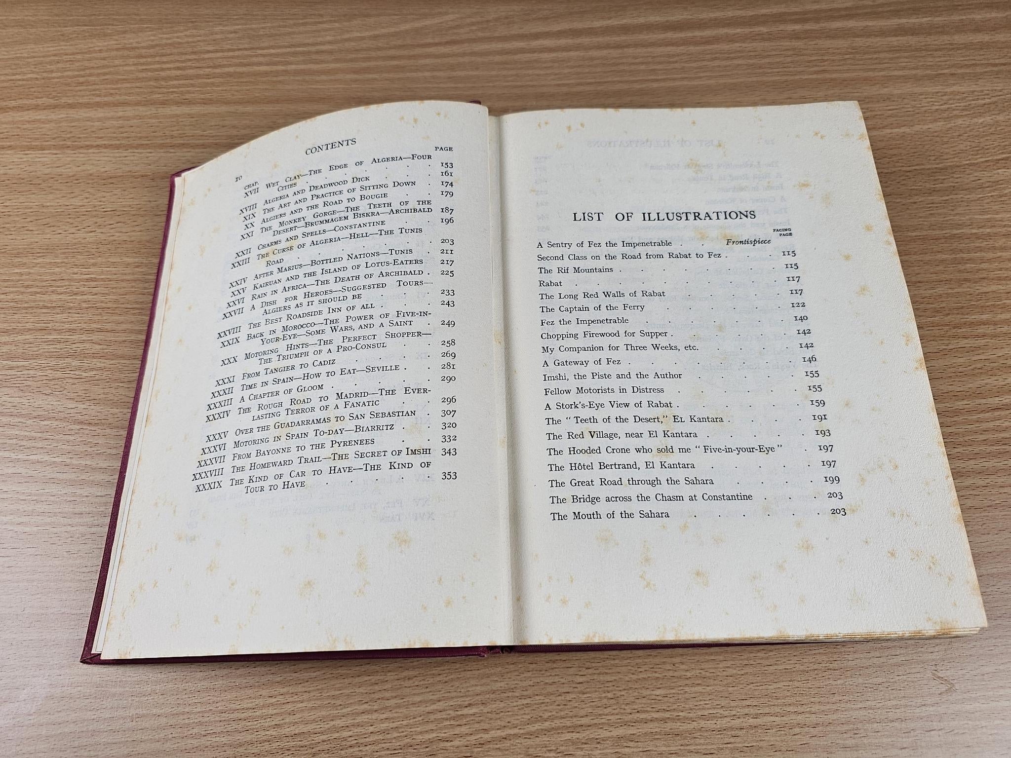 Opened vintage book with contents on left and list of illustrations on right