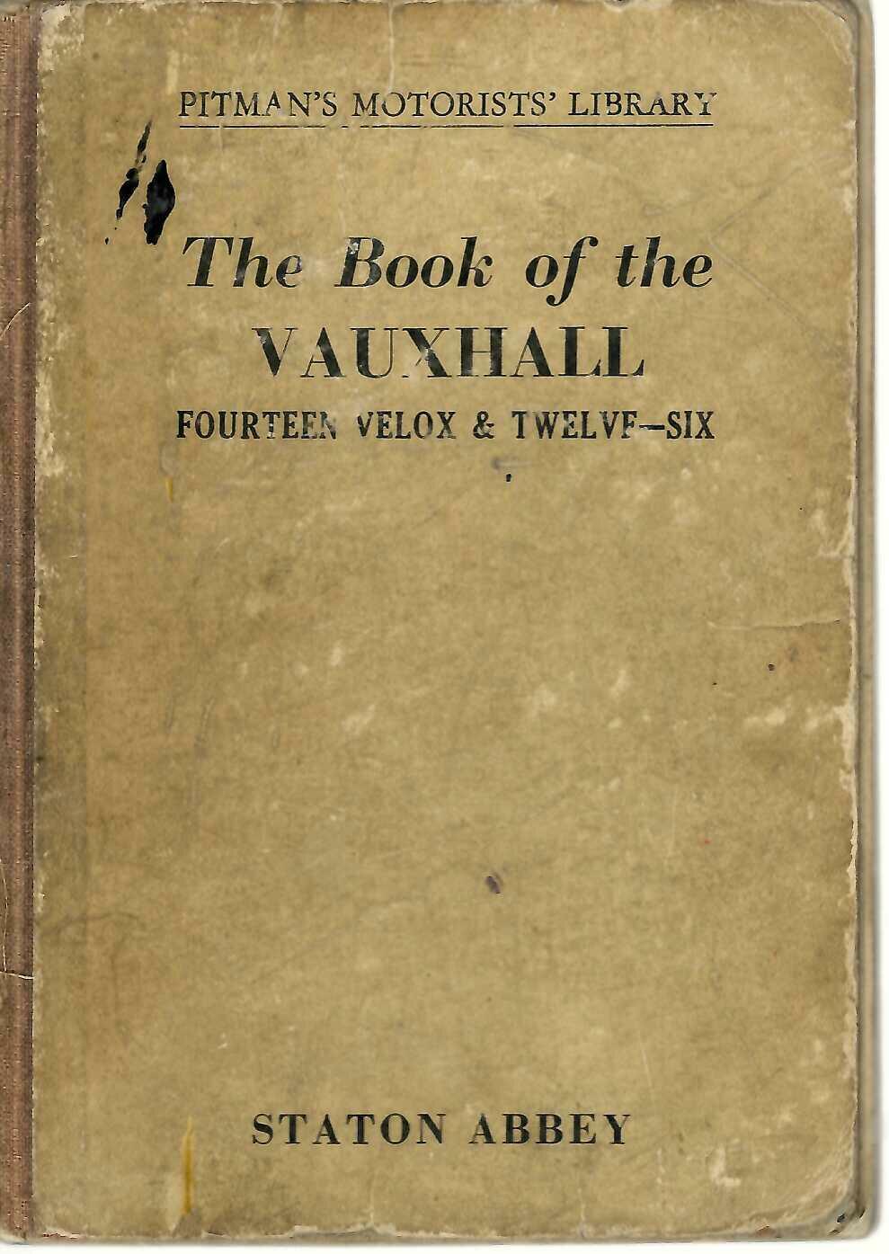 Vintage automotive manual book cover with title text and worn beige binding
