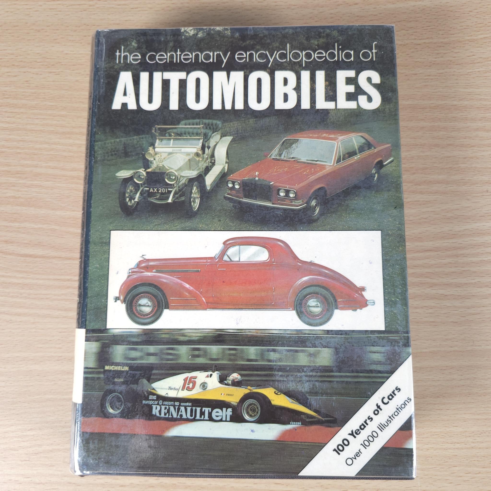 Automobiles encyclopedia book front cover, showing title, classic cars, and publisher label.