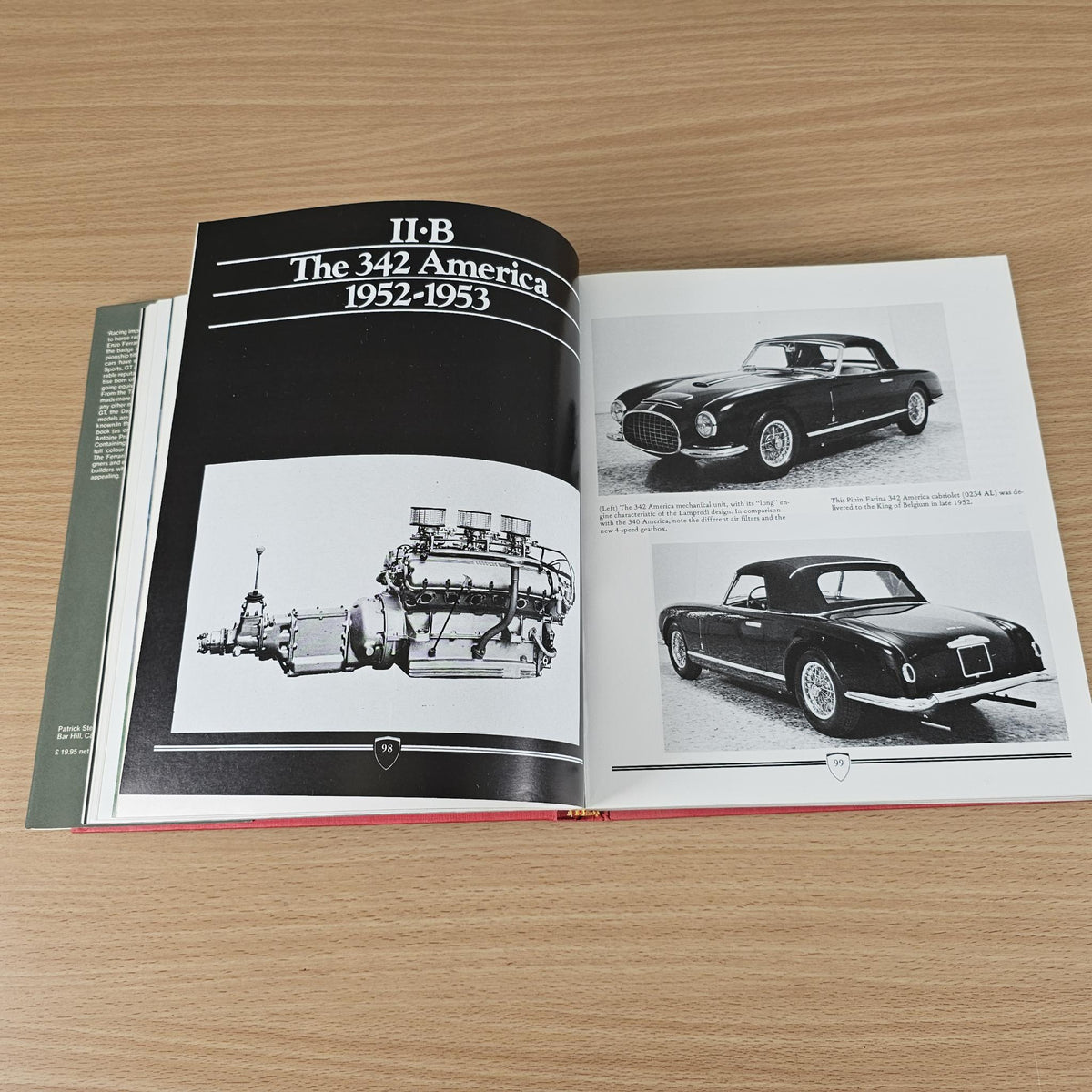 Open sports car book showing black car photo spread and engine illustration page.