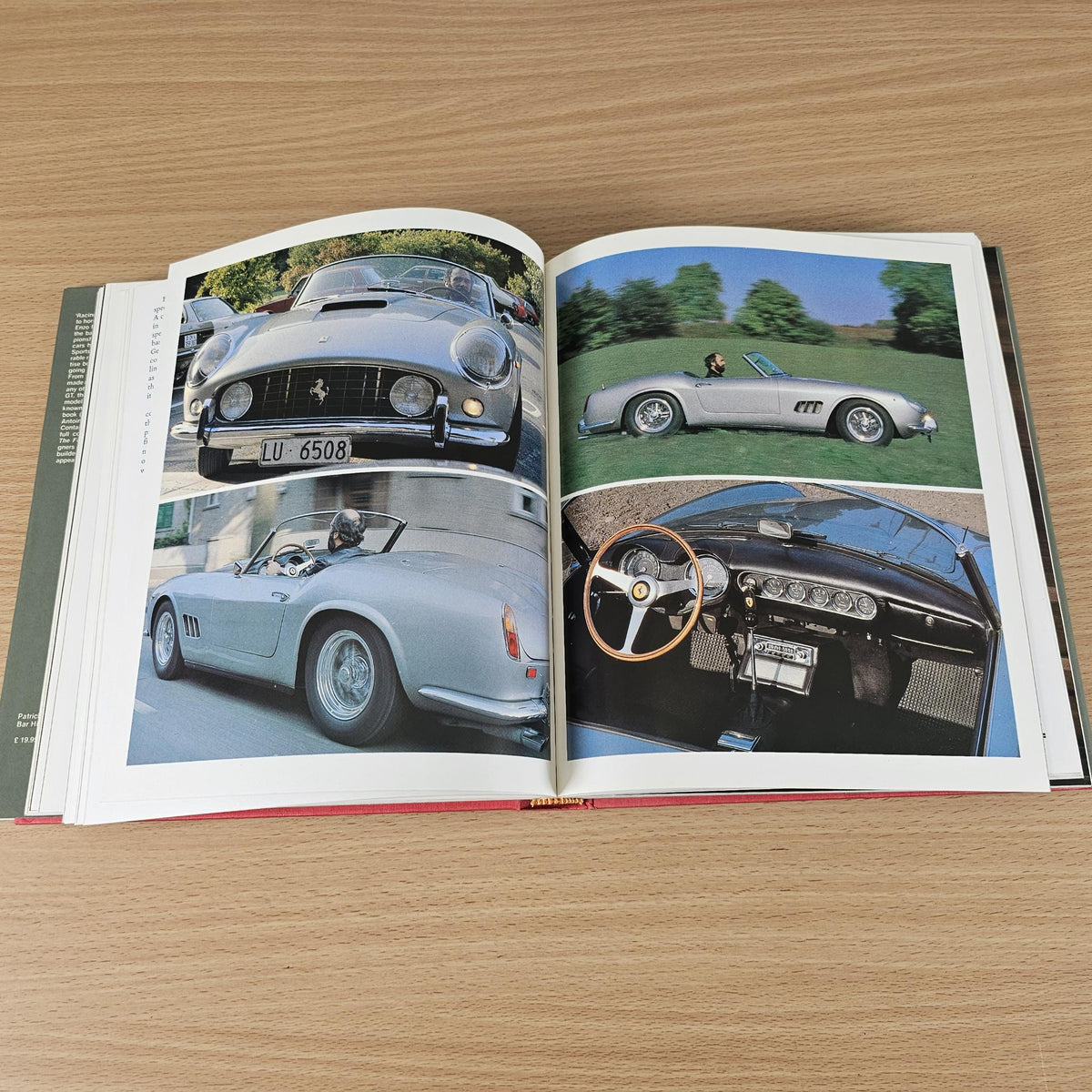 Open Ferrari car photo book with gray front car, green car, and interior spread.
