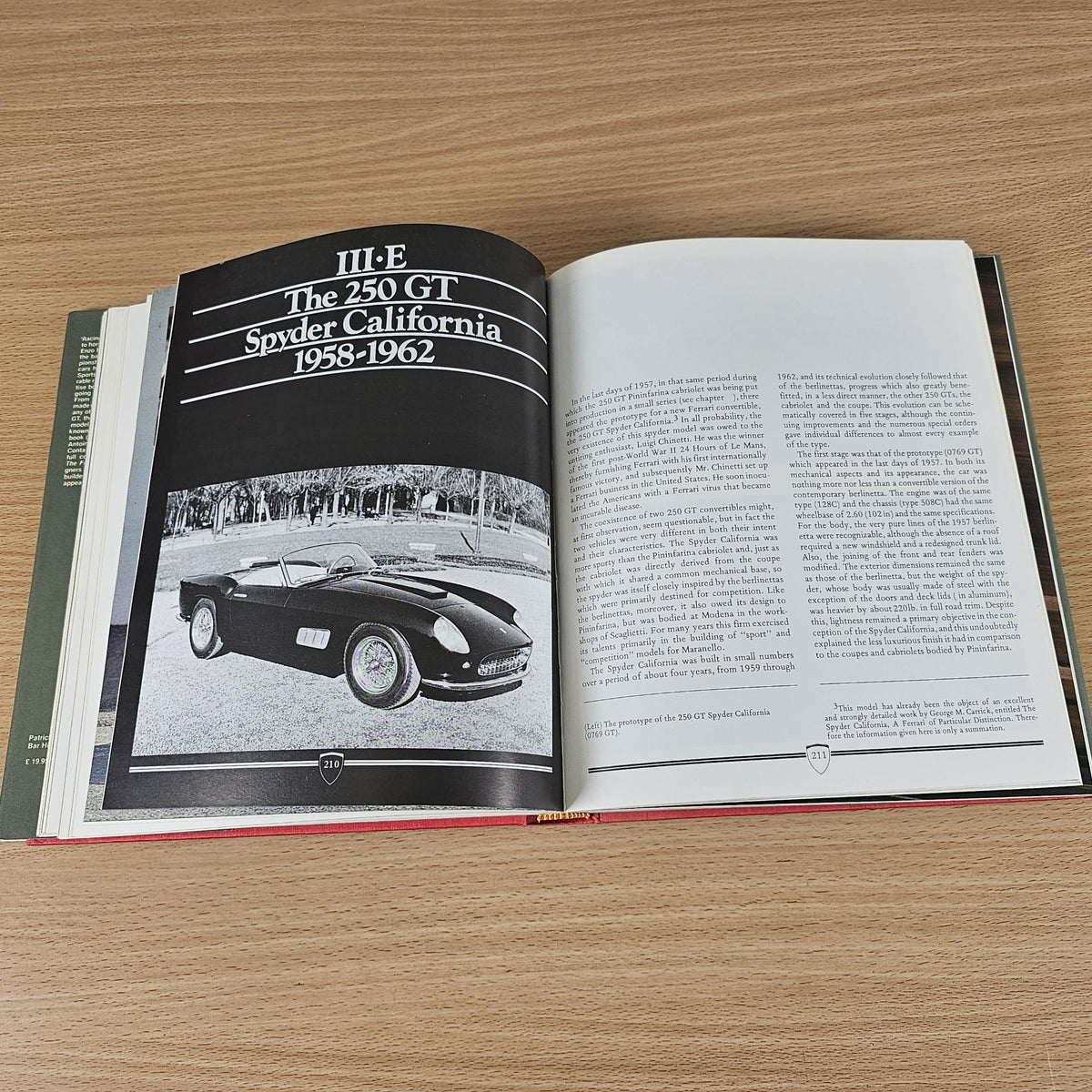 Open vintage sports car photo book featuring a black cover section and car images.