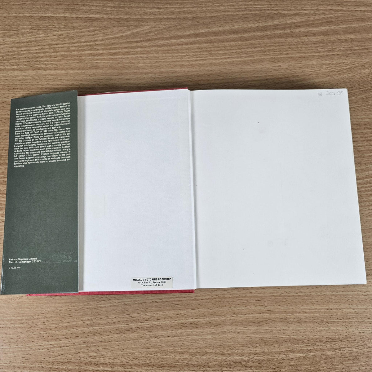 Ferrari book open spread with mostly blank pages and a narrow left text panel