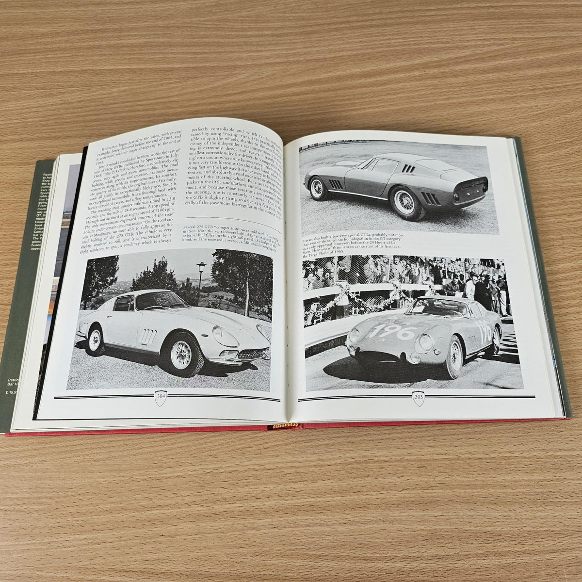 Ferrari road car book, open pages with grayscale car photos and printed text.