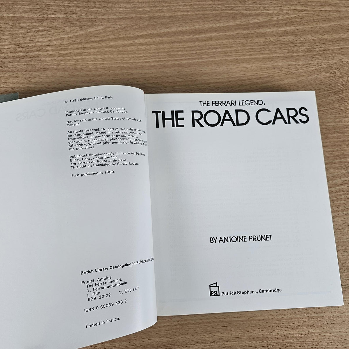Ferrari book open to title page with “THE ROAD CARS” and author name