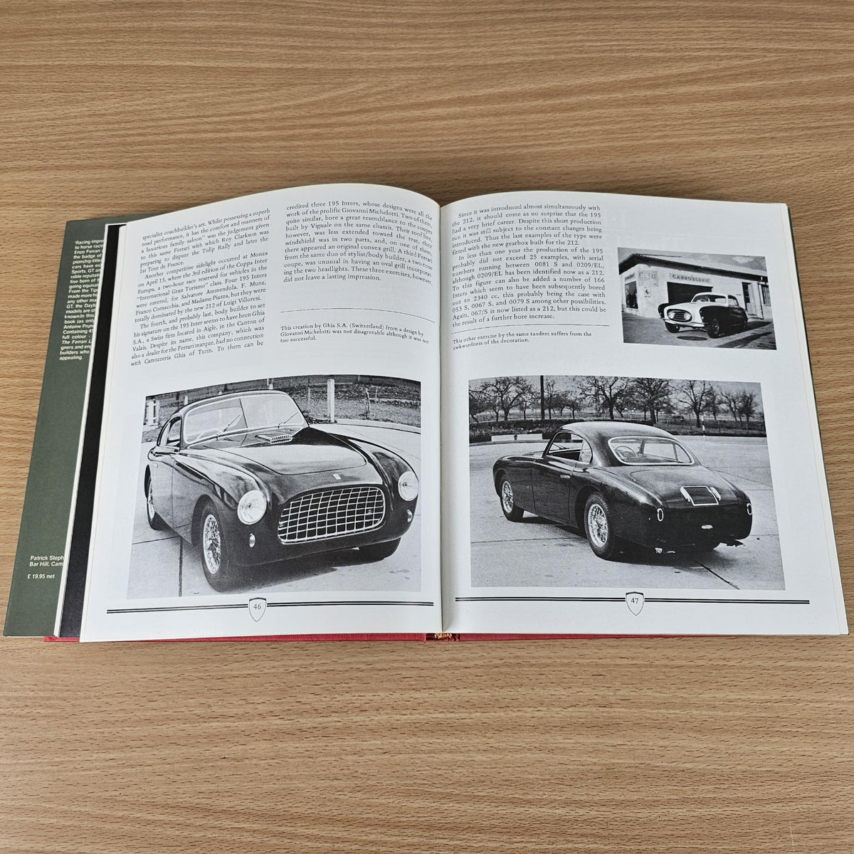 Ferrari book open to photo spread with vintage sports cars in black and white