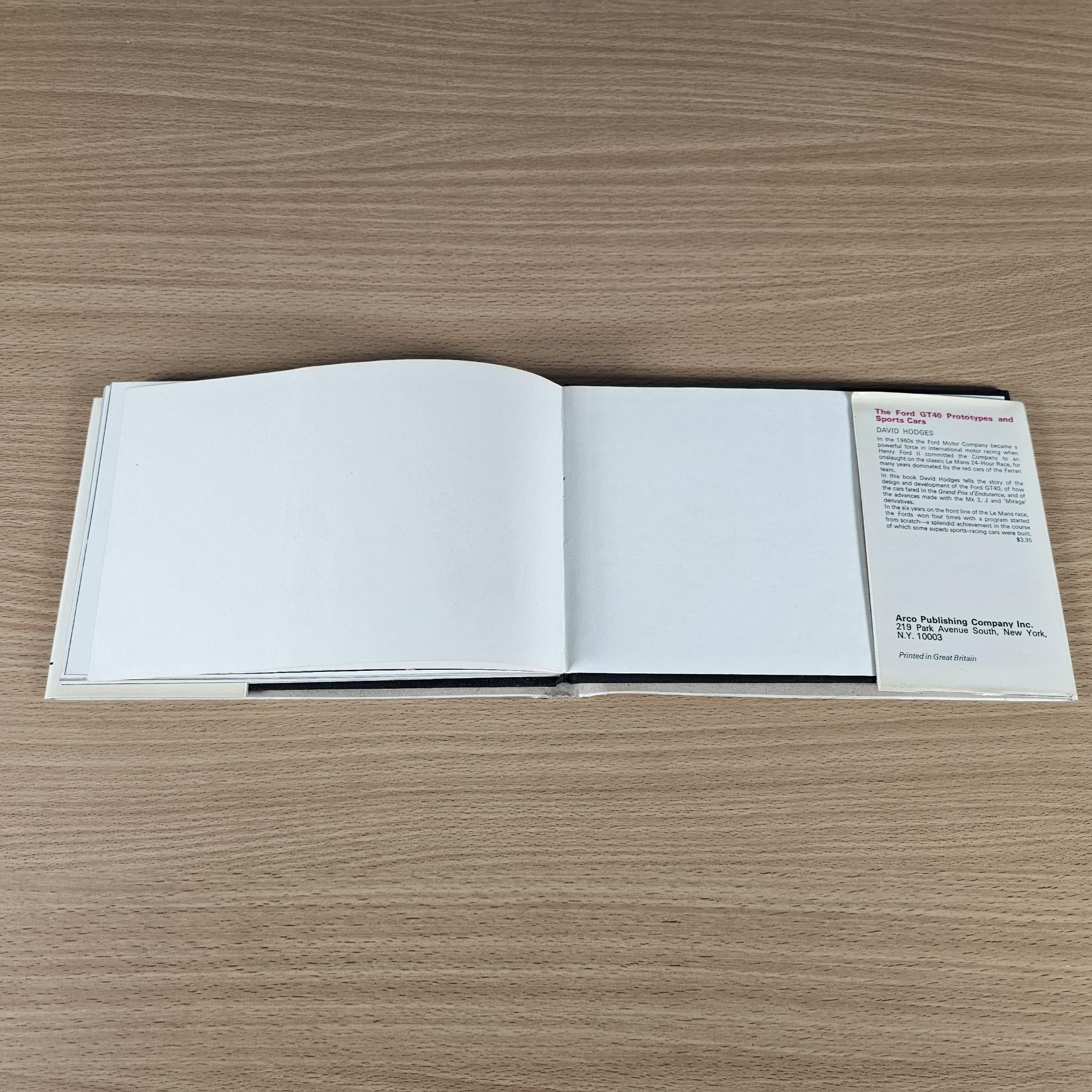 Vintage race photo book, open spread with blank pages and small text panel on the right