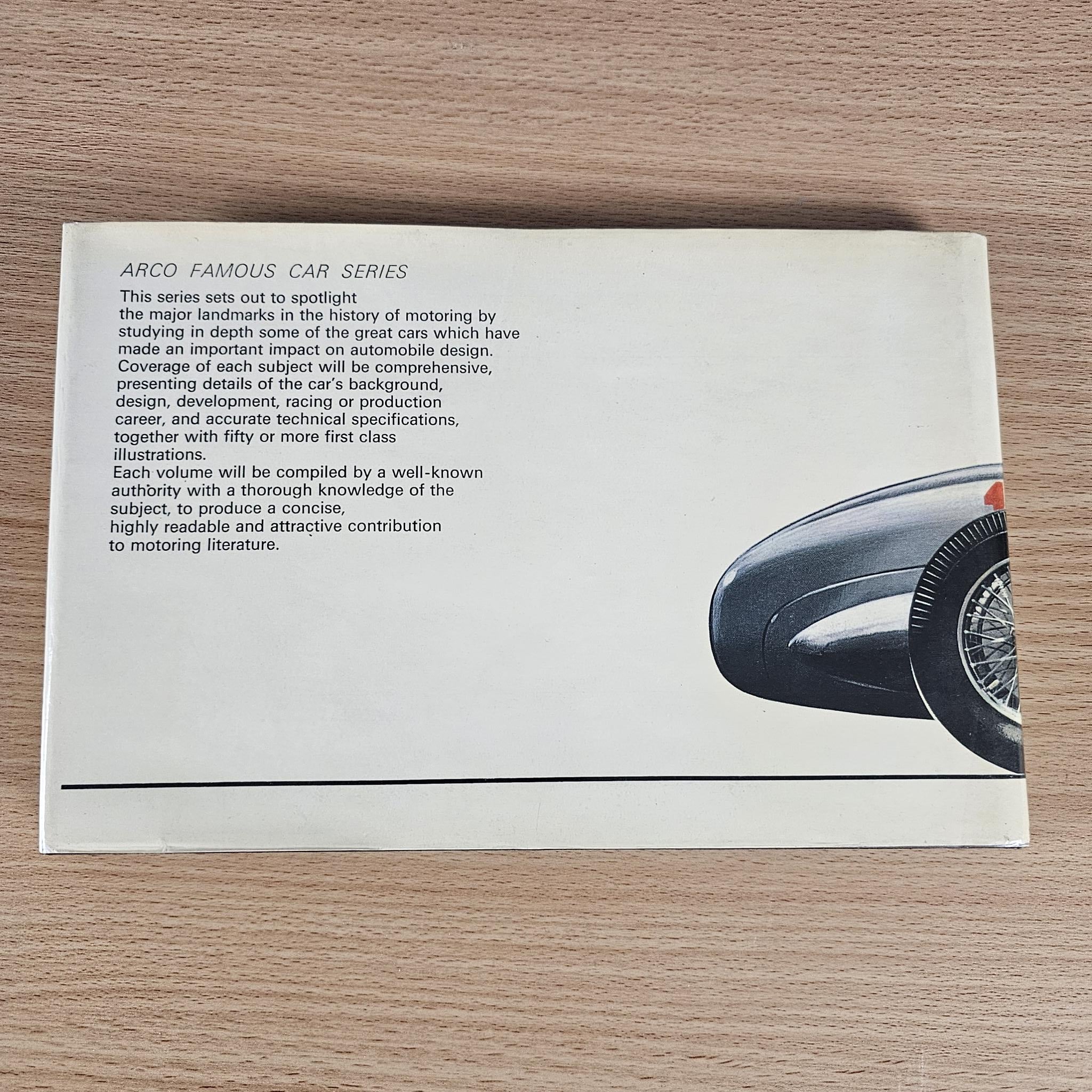 Race car book open to a text page with part of a car illustration