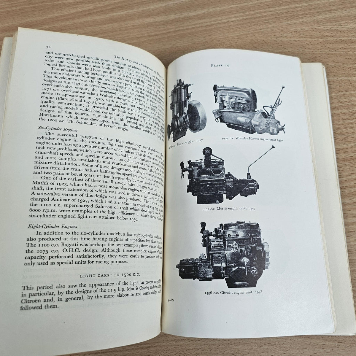 Open paperback book with grayscale vehicle photos and technical text on both pages