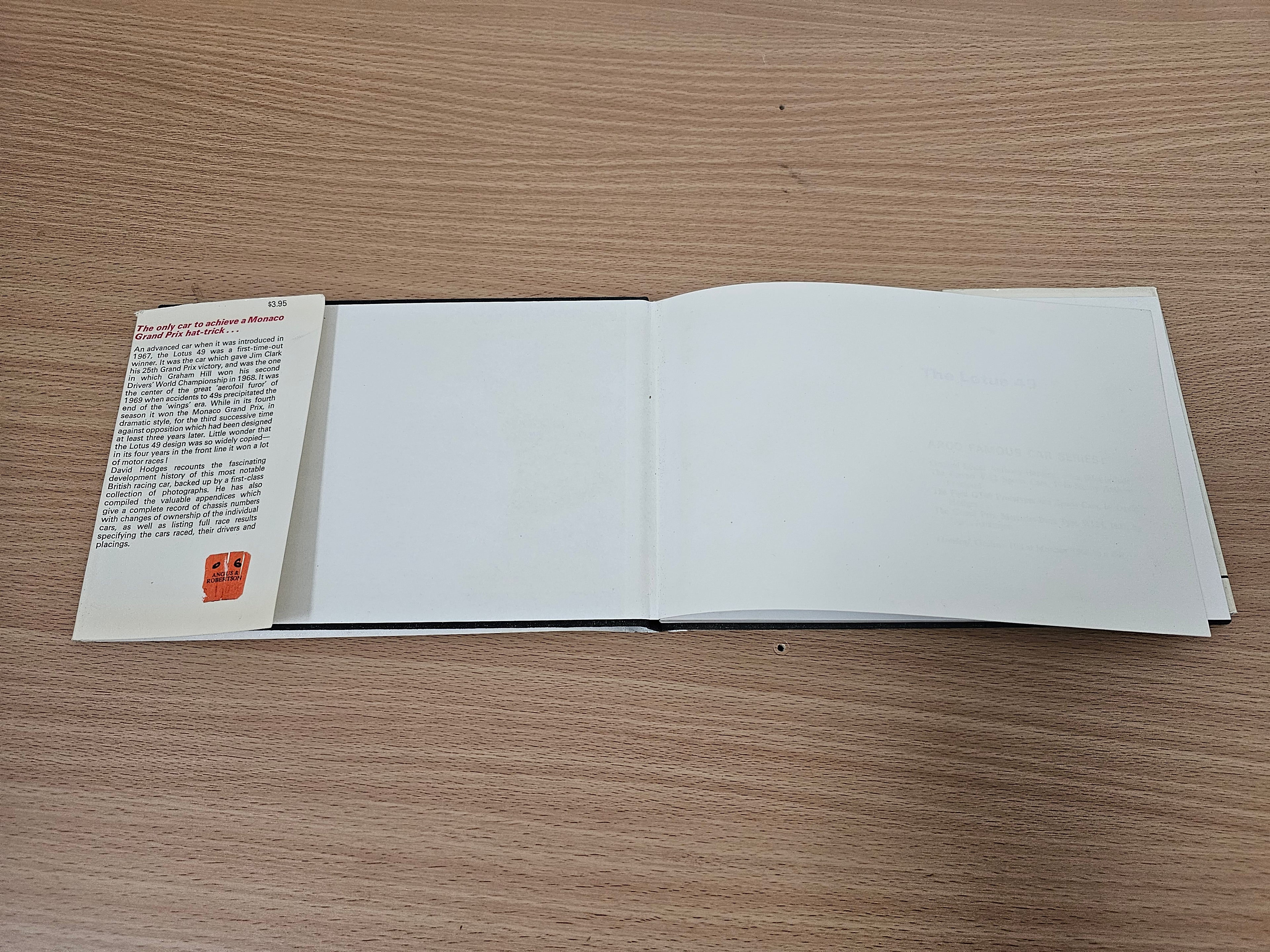 Open book with blank white pages and a small text page on the left