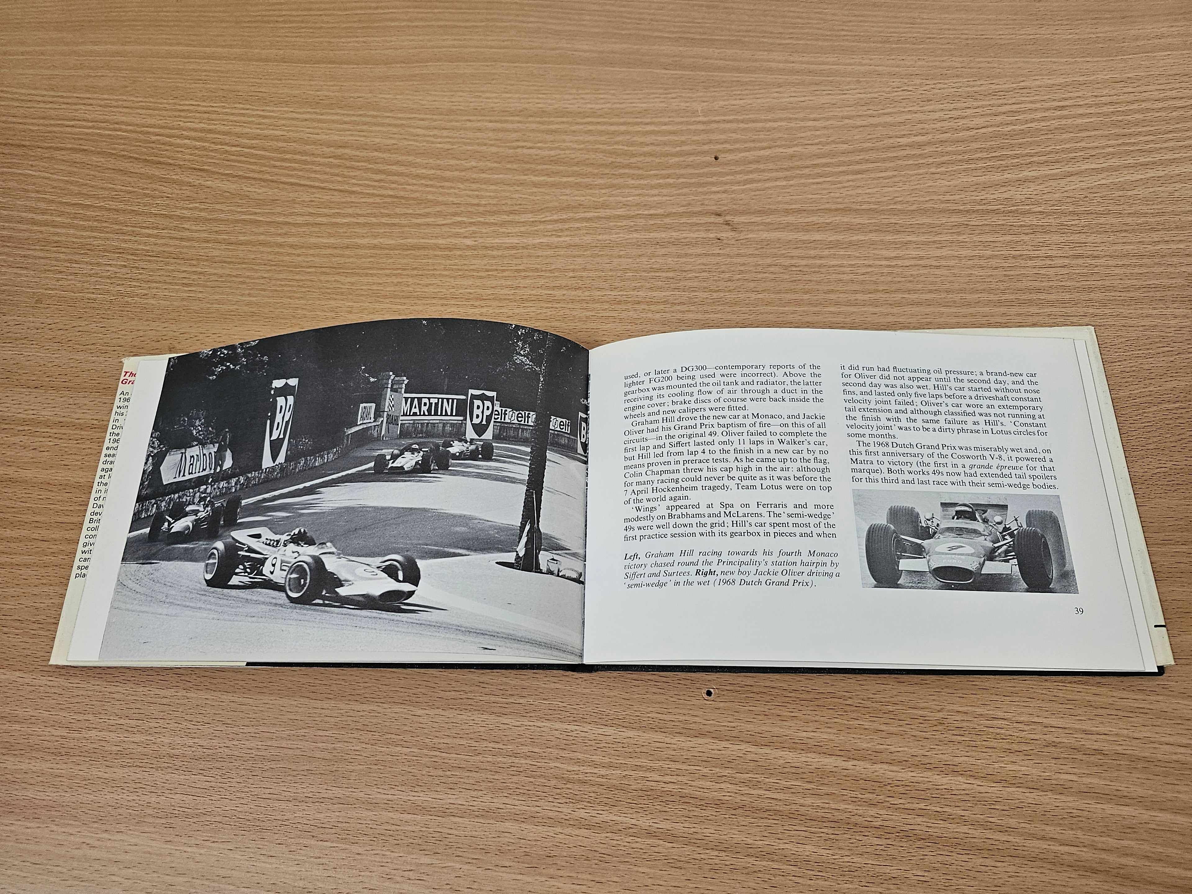 Open book spread with black-and-white race car action photo and dense text