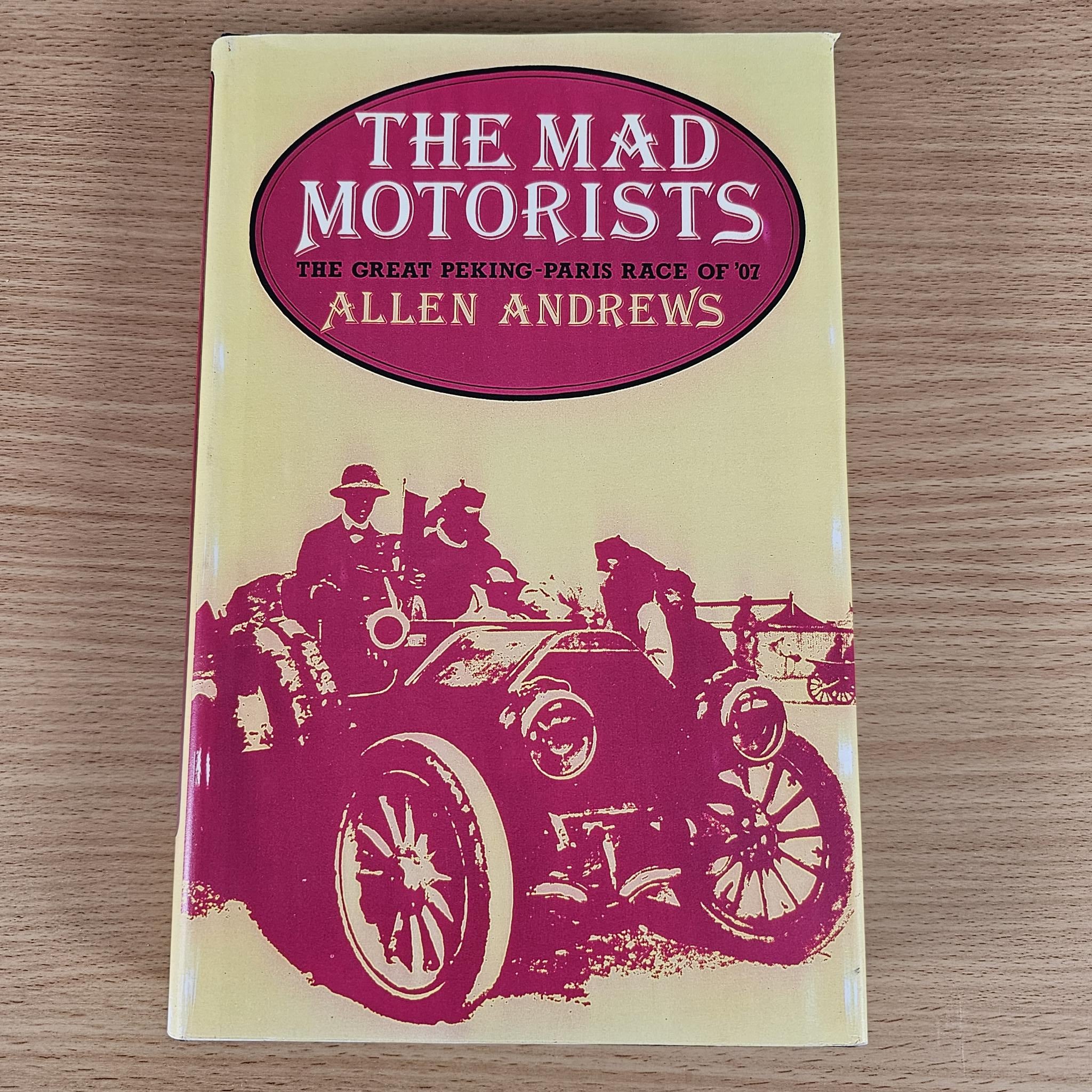 Vintage hardcover book with maroon title oval and maroon race illustration on pale yellow cover