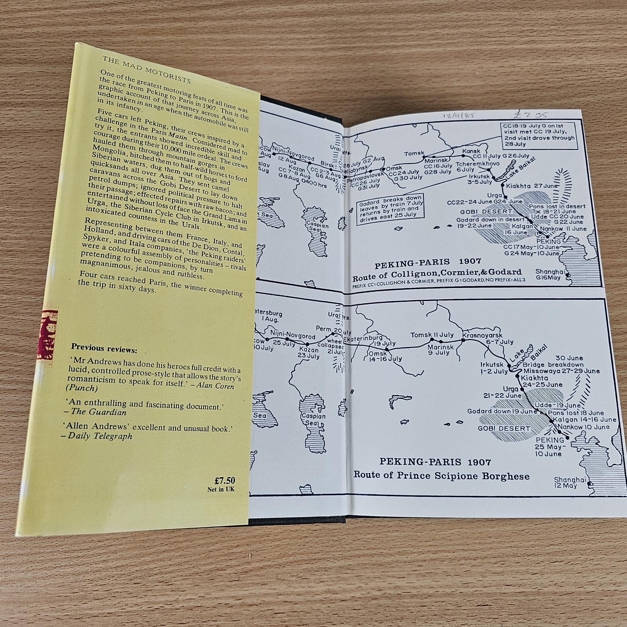 Open book showing route map of Peking to Paris with columns of small text and dates