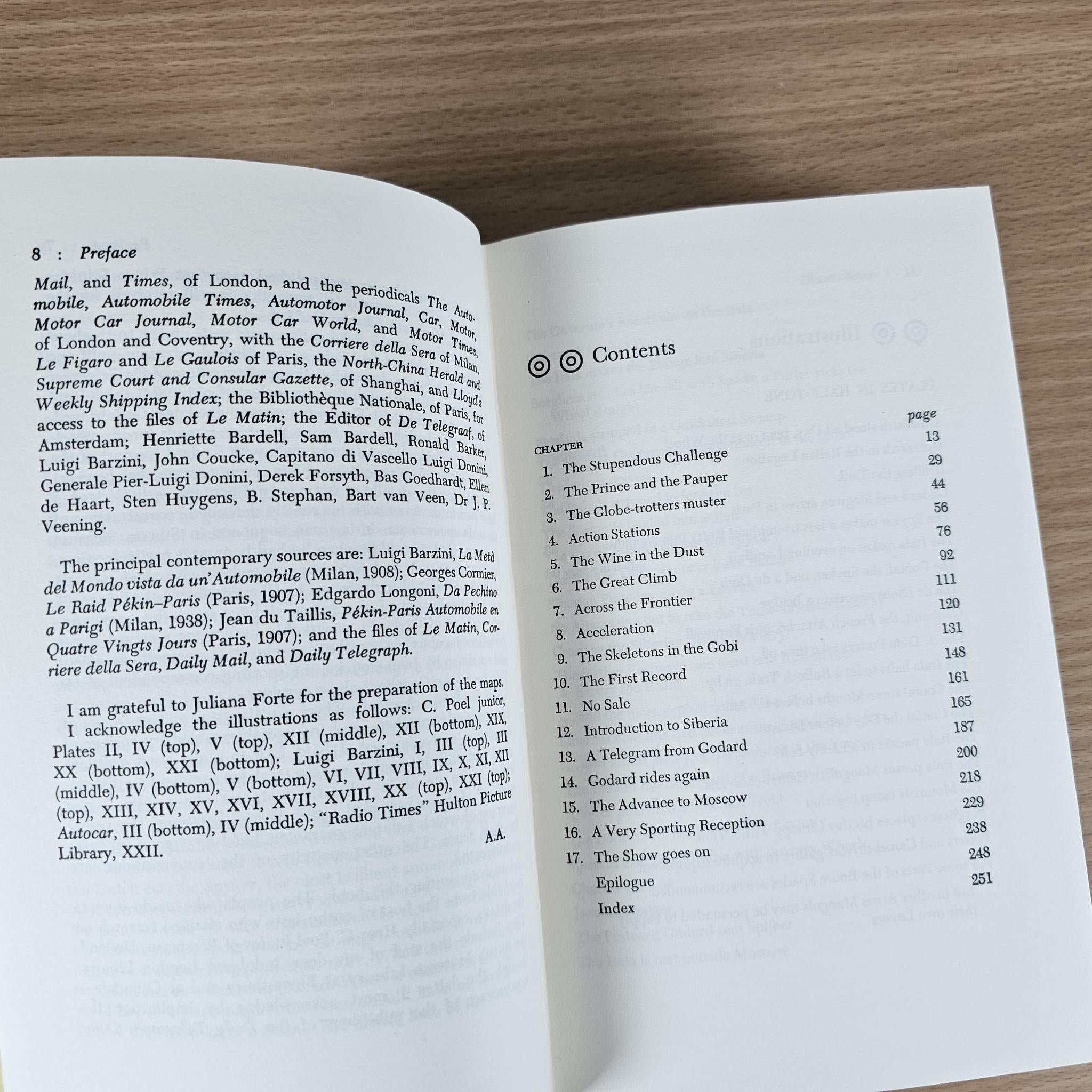 Open book with “Contents” page and numbered section list on white paper