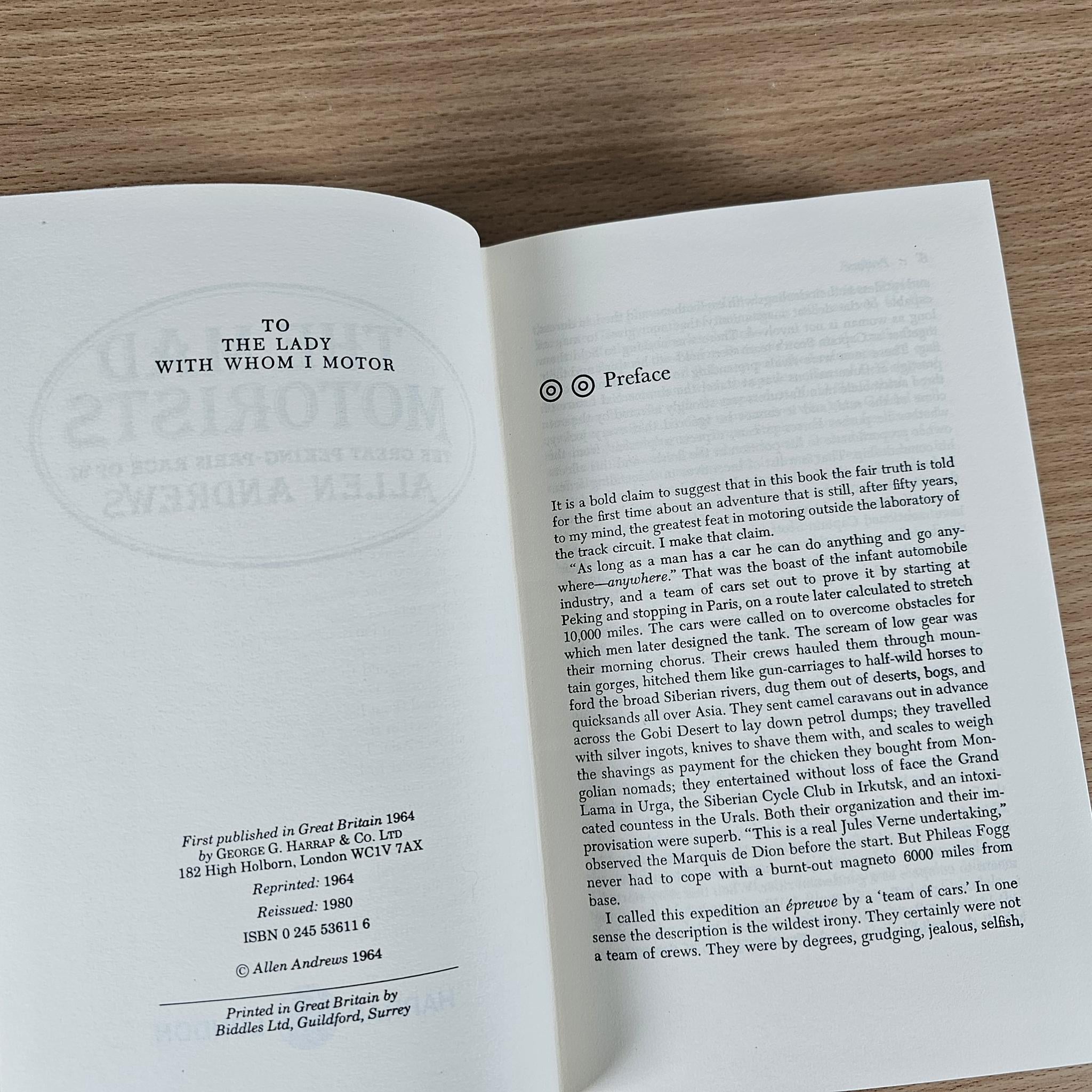 Open book showing dedication page and preface text on white paper
