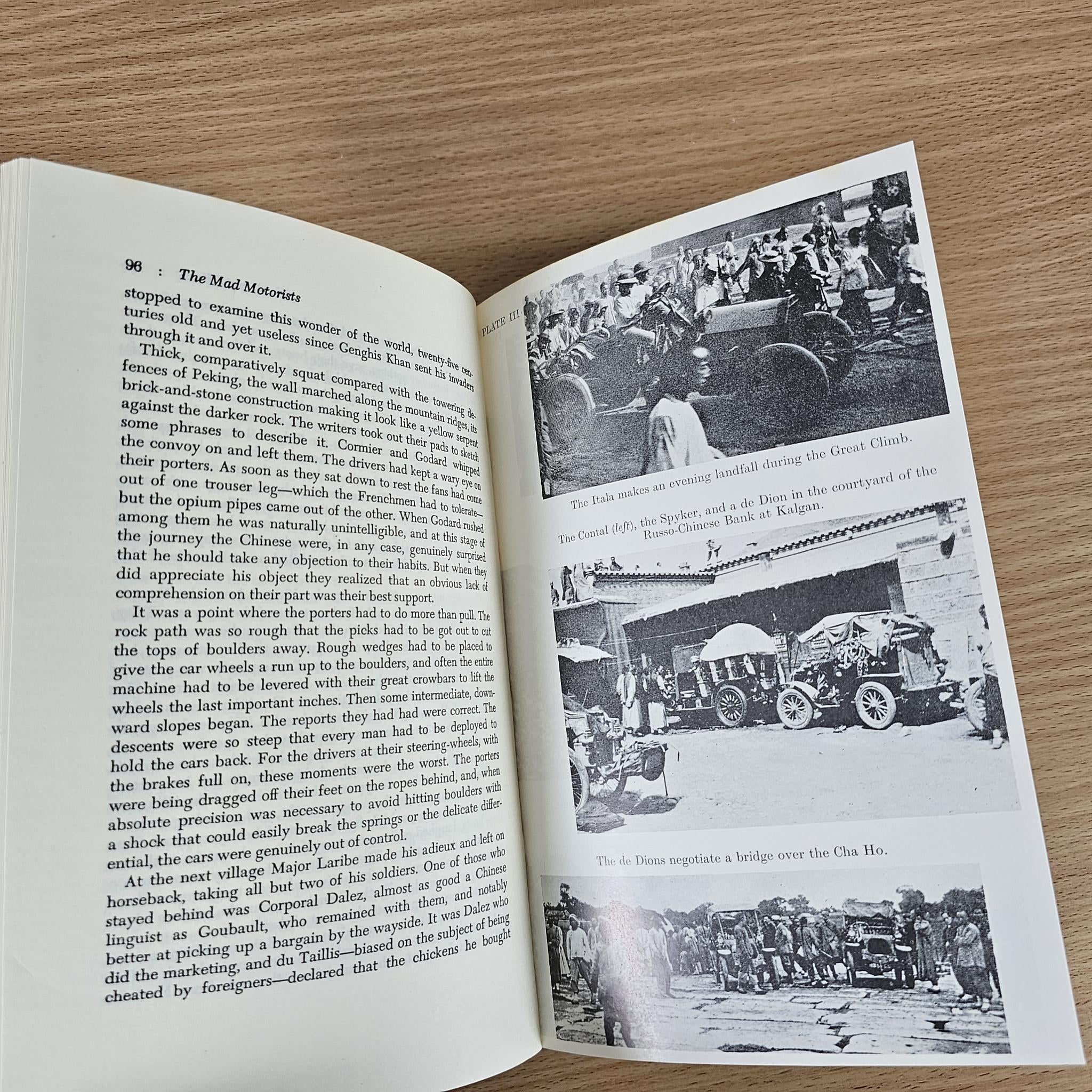 Open book spread with paragraphs and black-and-white historical photos of motor race