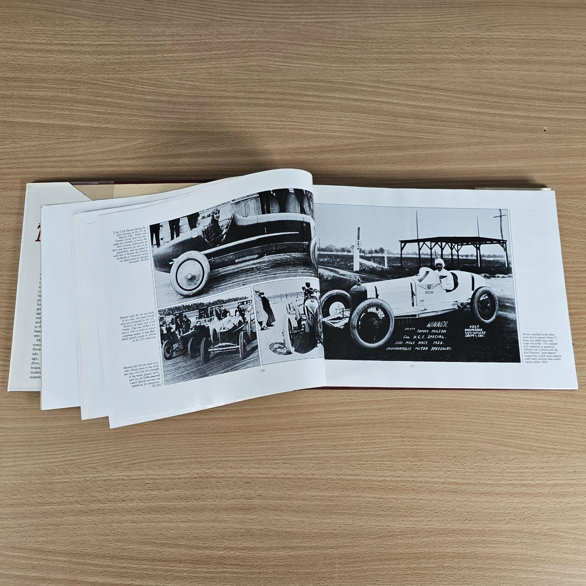 Open book spread with black-and-white car images and printed technical text