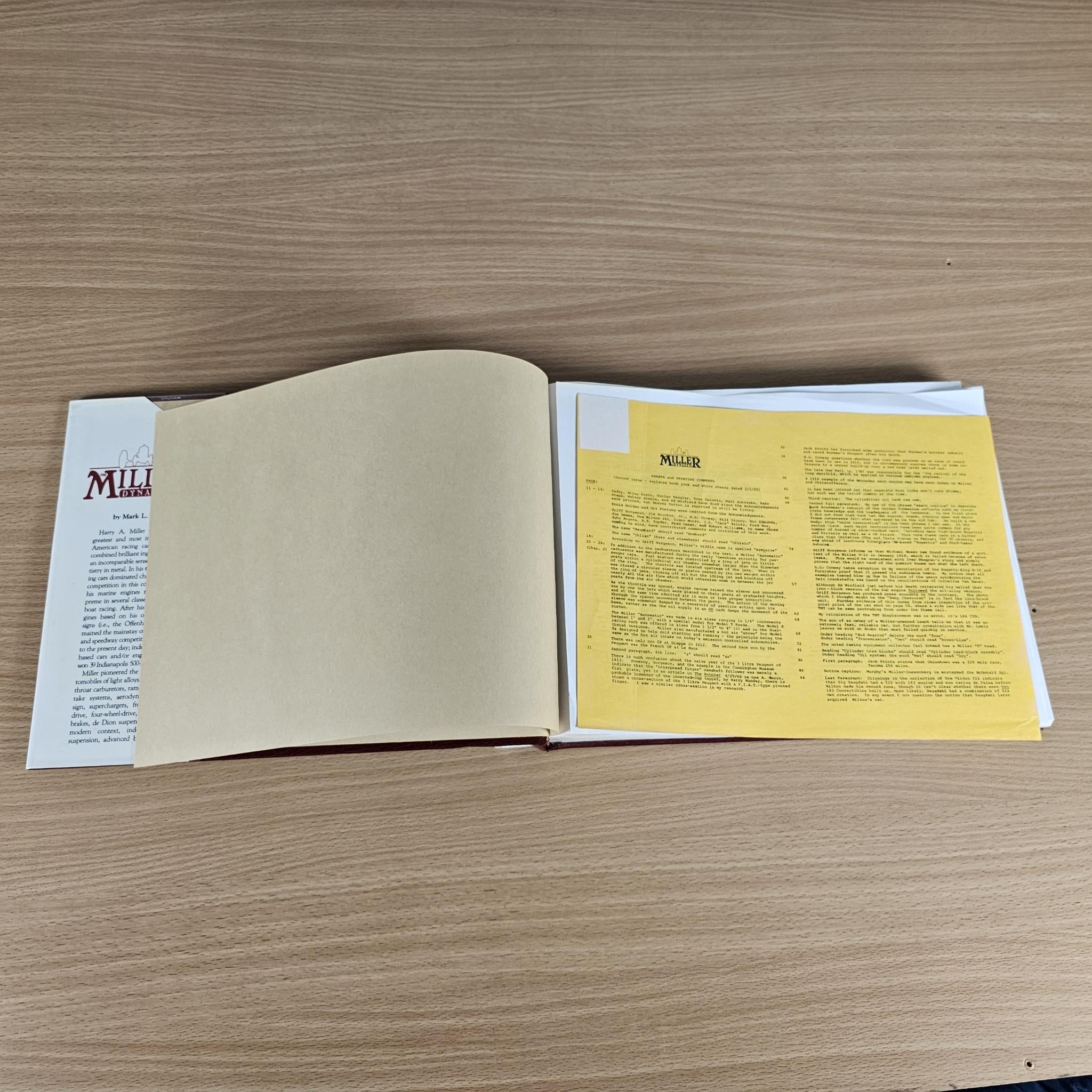 Miller Dynasty history book open, showing white pages with yellow text section
