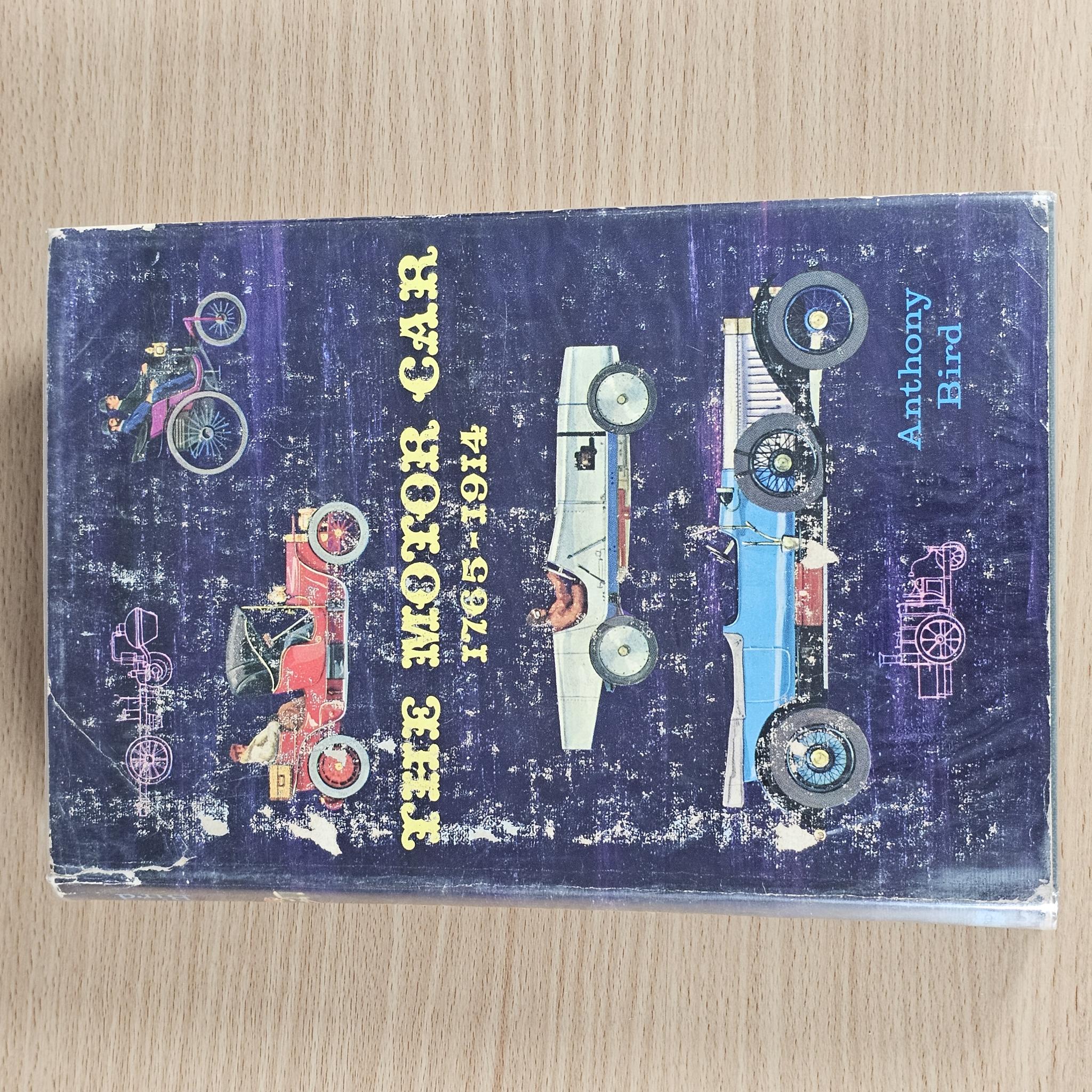 Motor car history book on wood with blue cover and vehicle title lettering