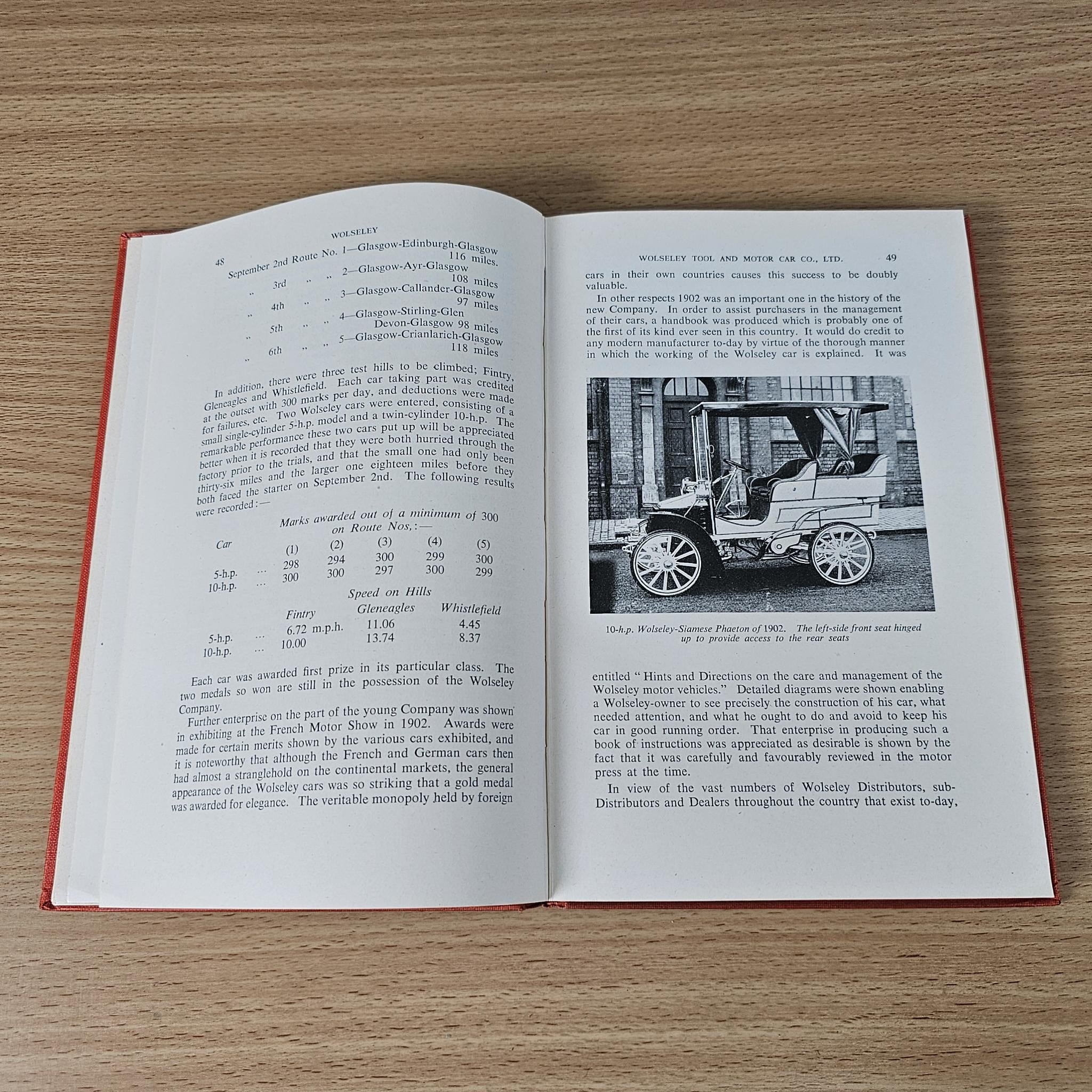 Open book with text on left page and a vintage vehicle photo on the right