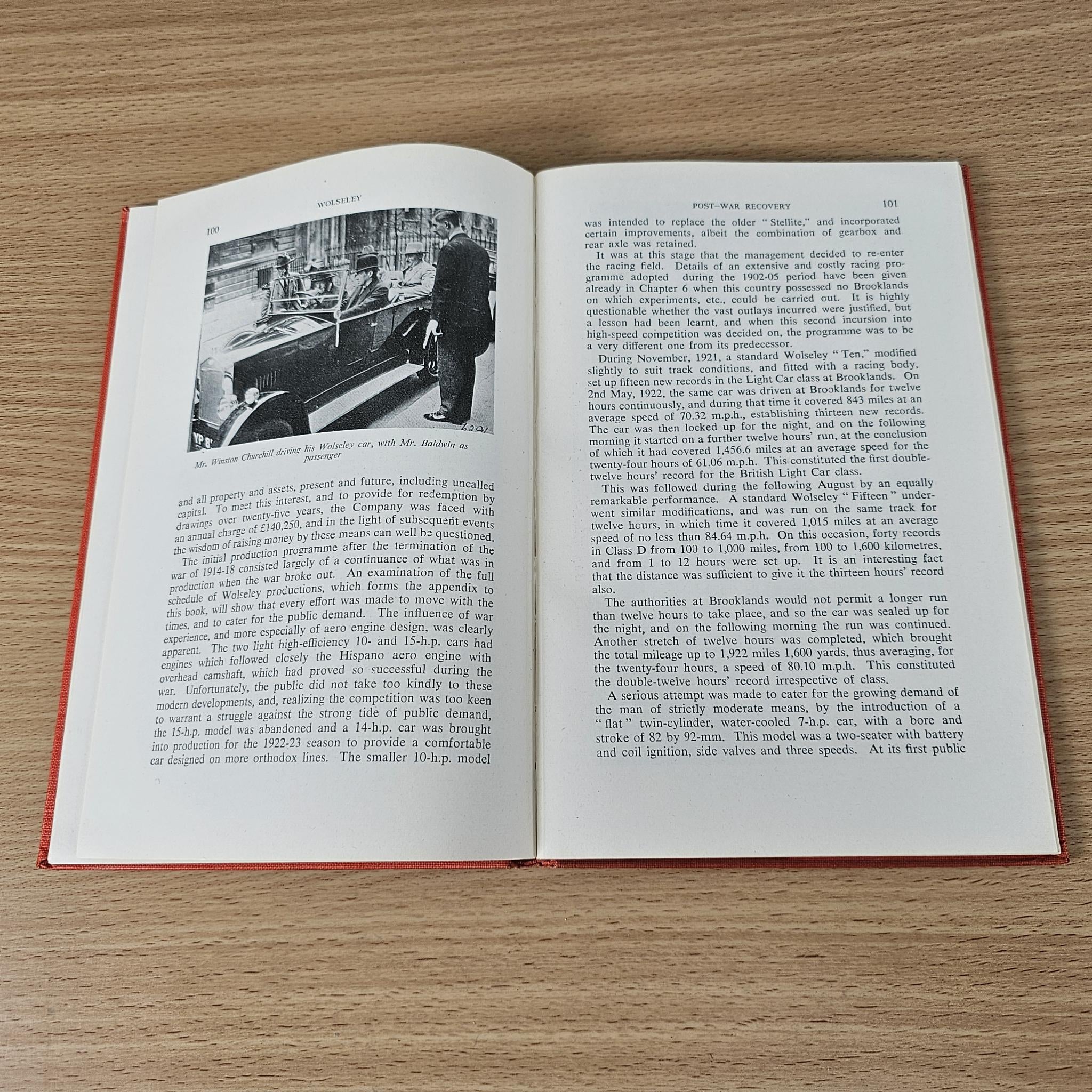 Open book with a black-and-white workshop photo on the left and paragraphs on the right