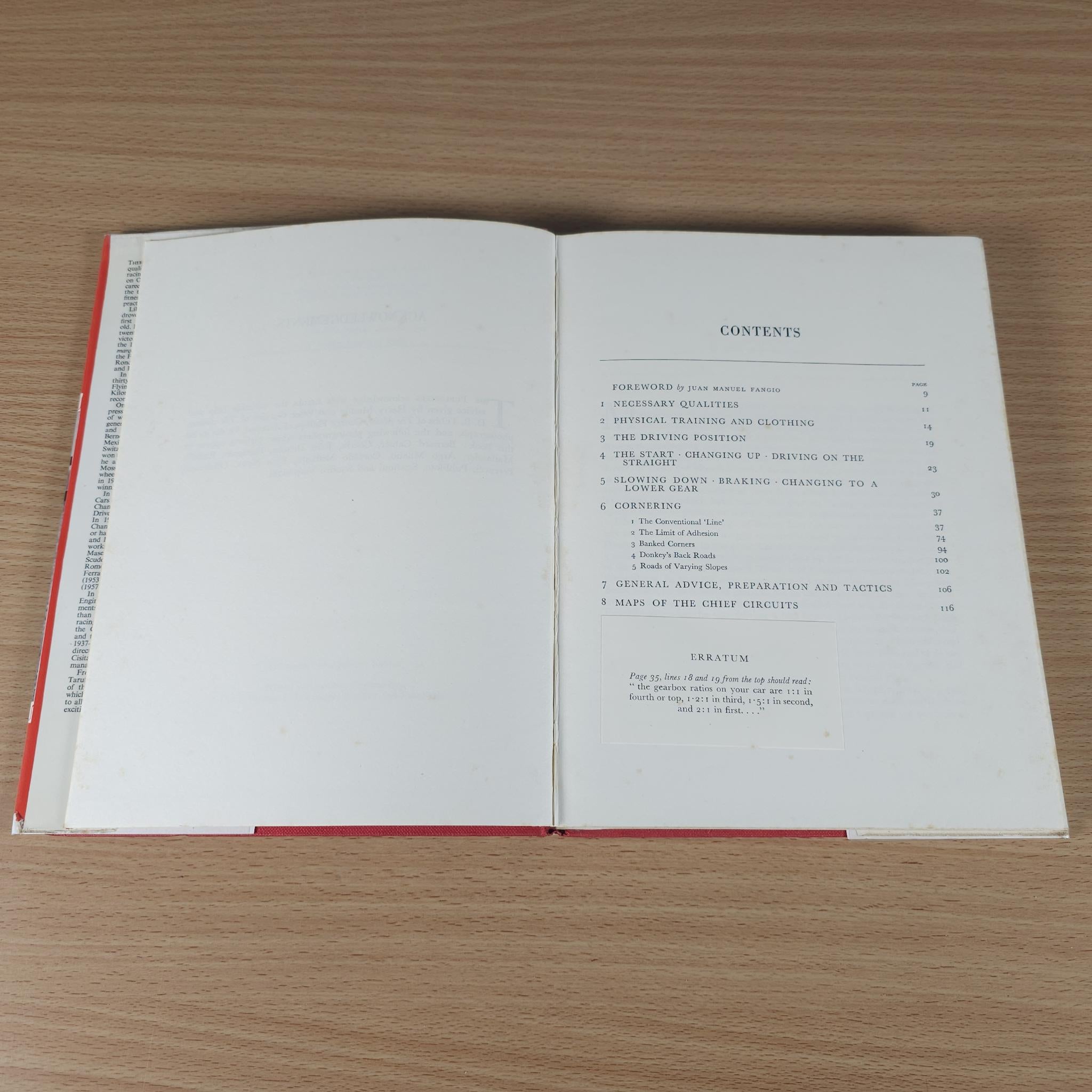 Open motor racing book showing contents page with section list and red-edged binding