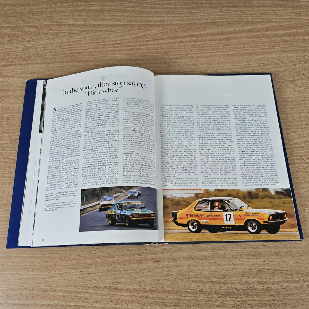 Hardcover book with open pages, text, and color photos of racing cars on track