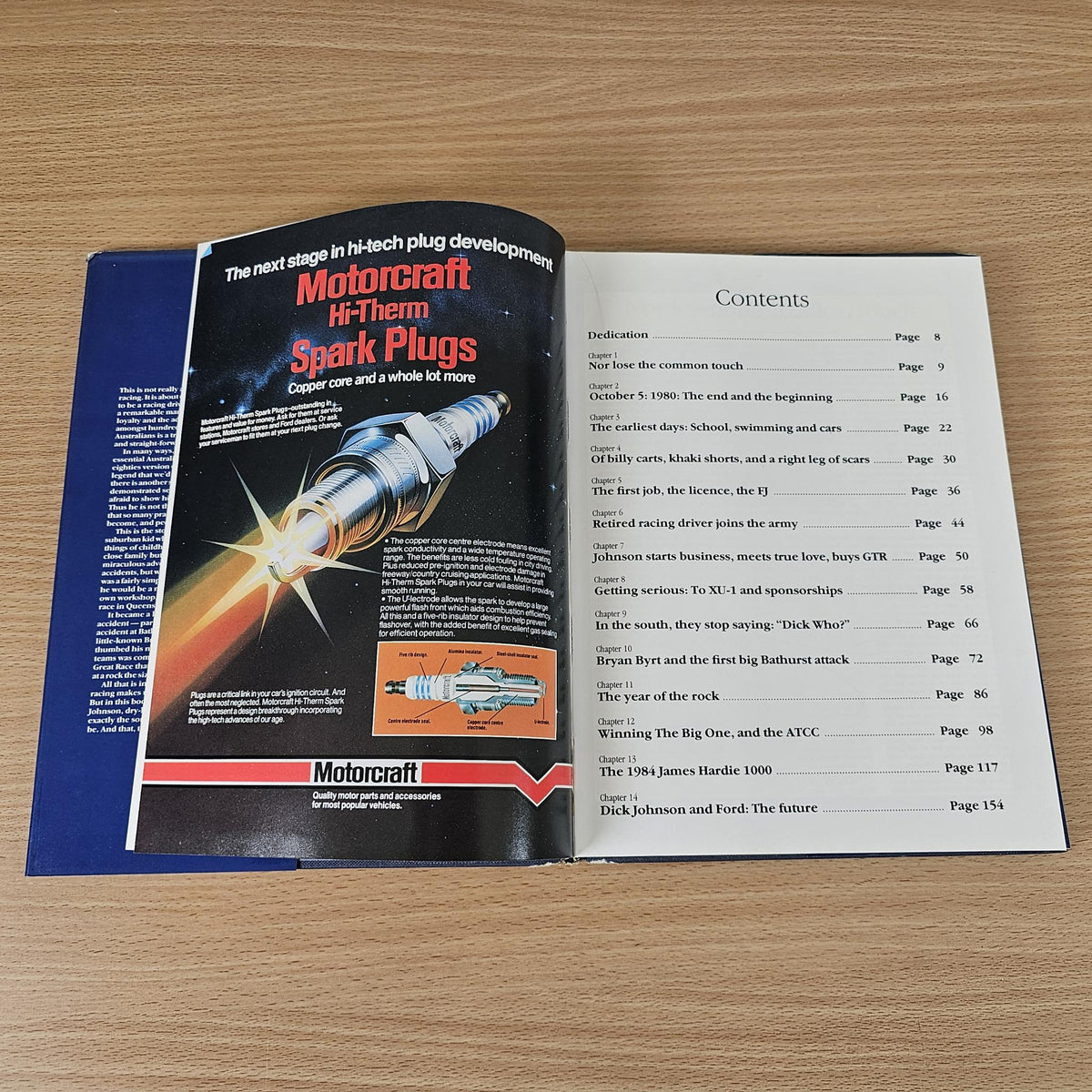Opened hardcover book showing contents page and “Motorcraft Hi-Them Spark Plugs”