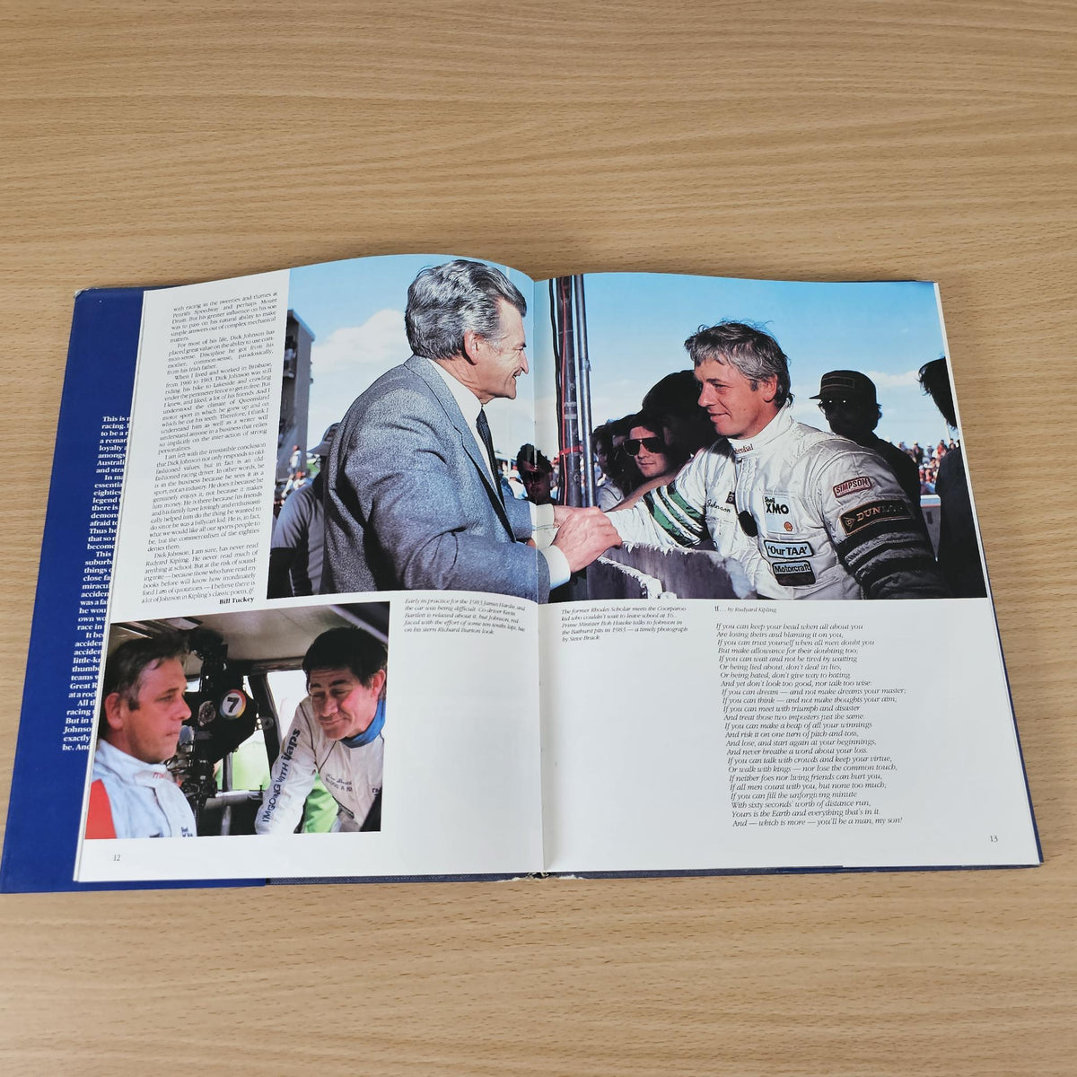 Opened hardcover book with photo spread of two men talking and printed article text