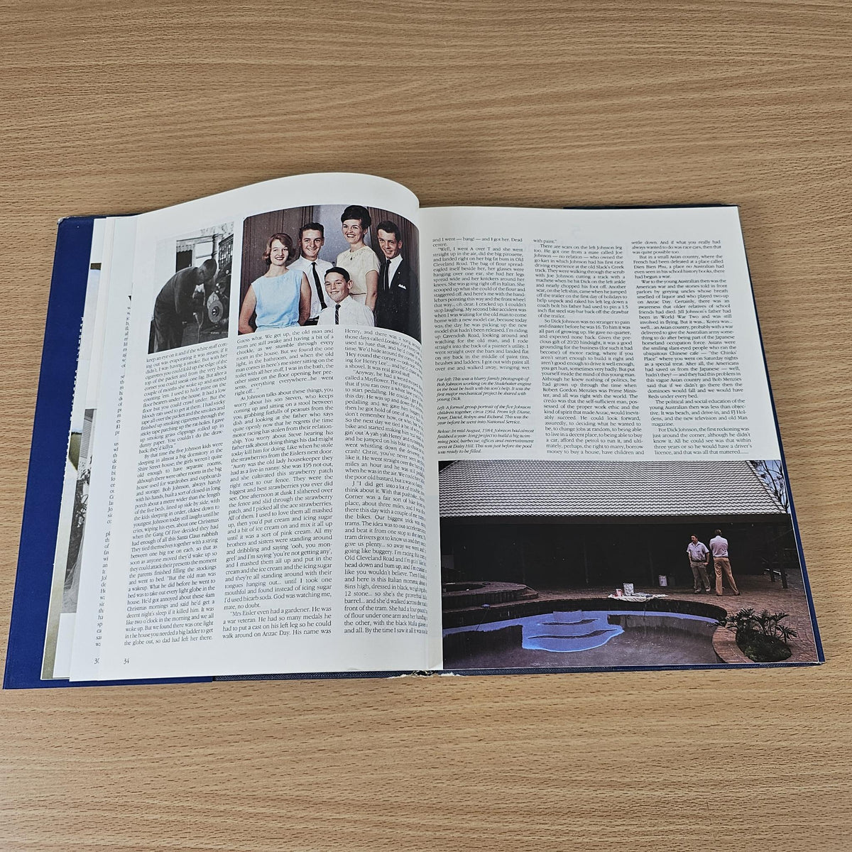 Opened hardcover book with group portrait photo and columns of article text