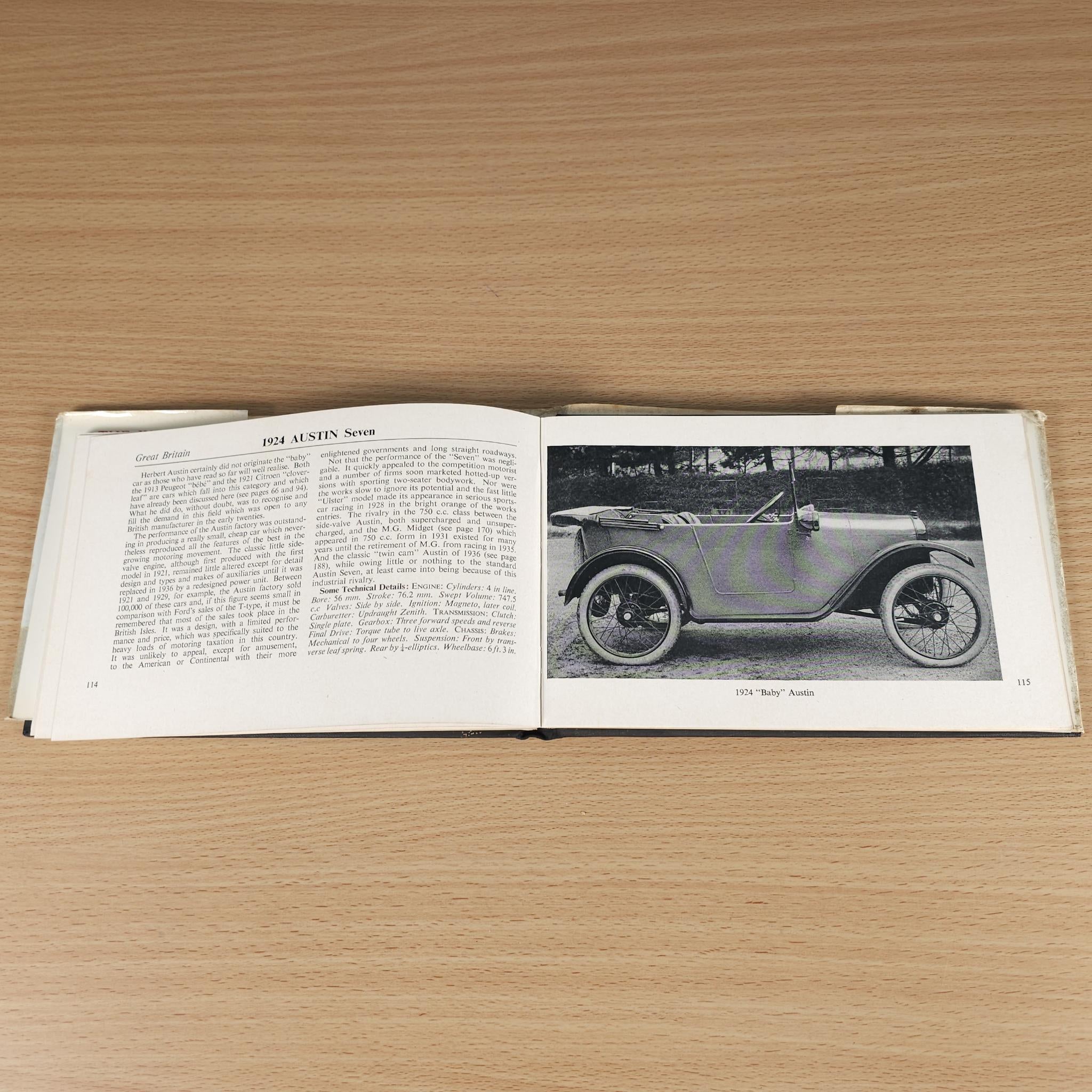 Vintage car guide book, open pages with text and blue side-view car photo