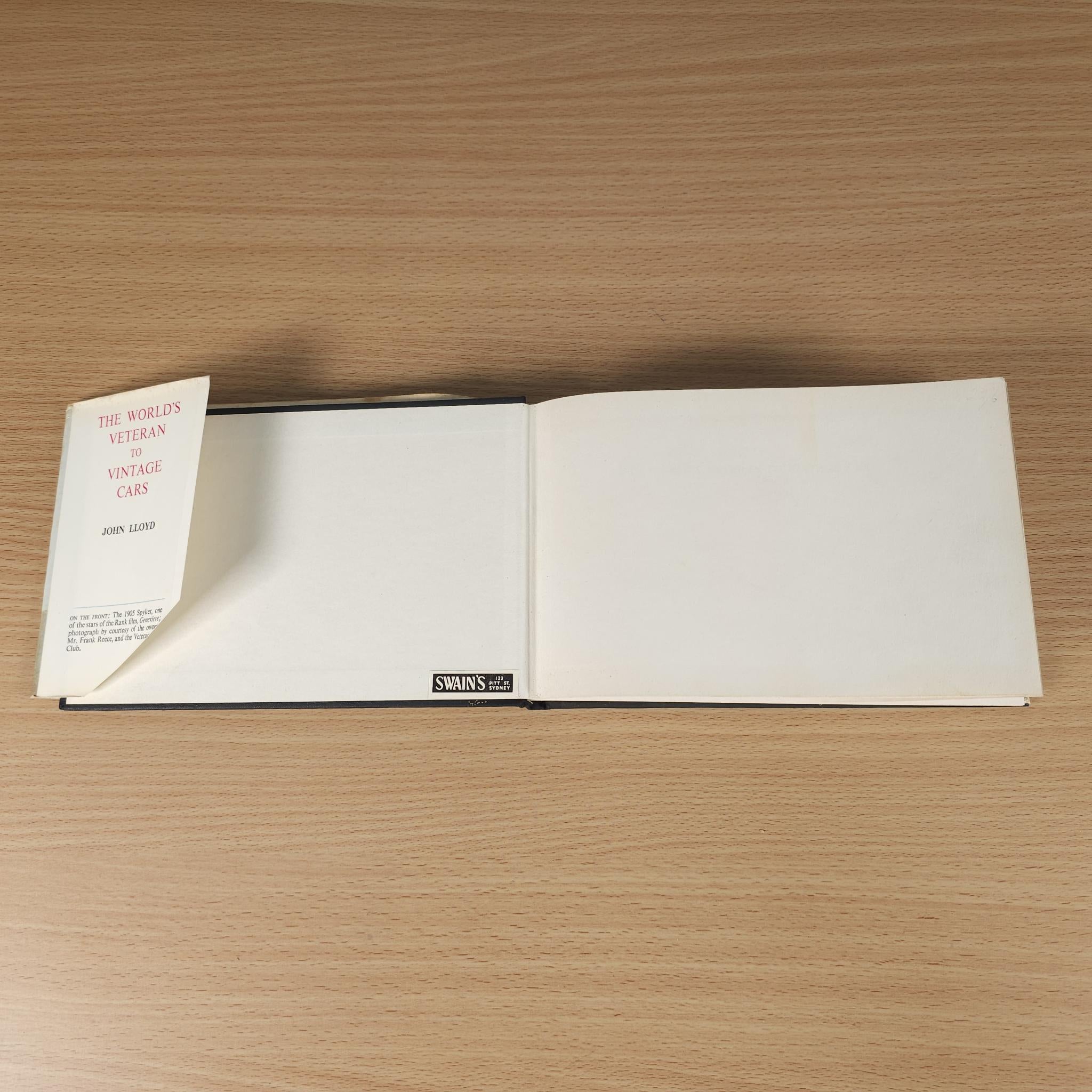 Opened vintage car book with blank white pages and a bookmark tab