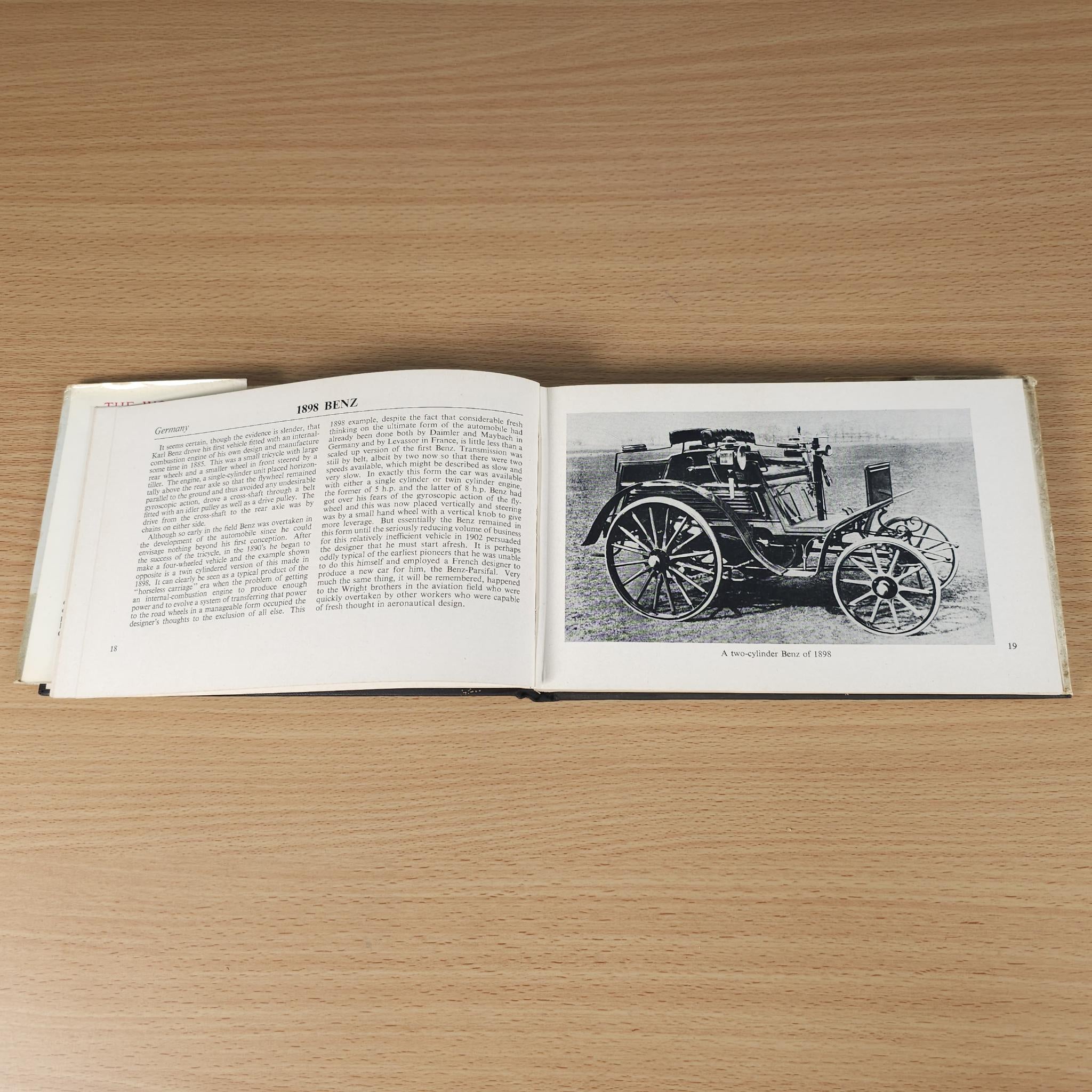Opened vintage car book with car photo inset on the right page