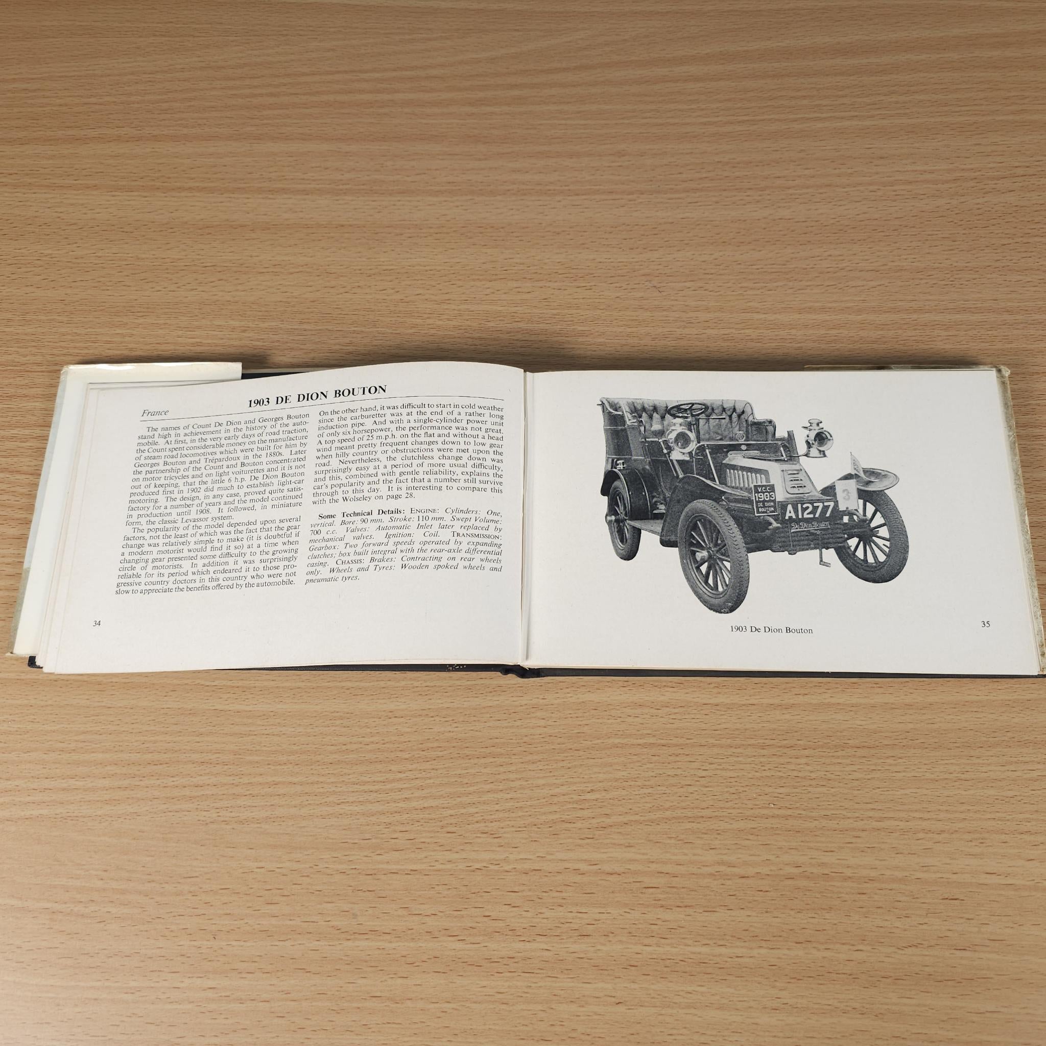 Opened vintage car book with car photo inset on the right page
