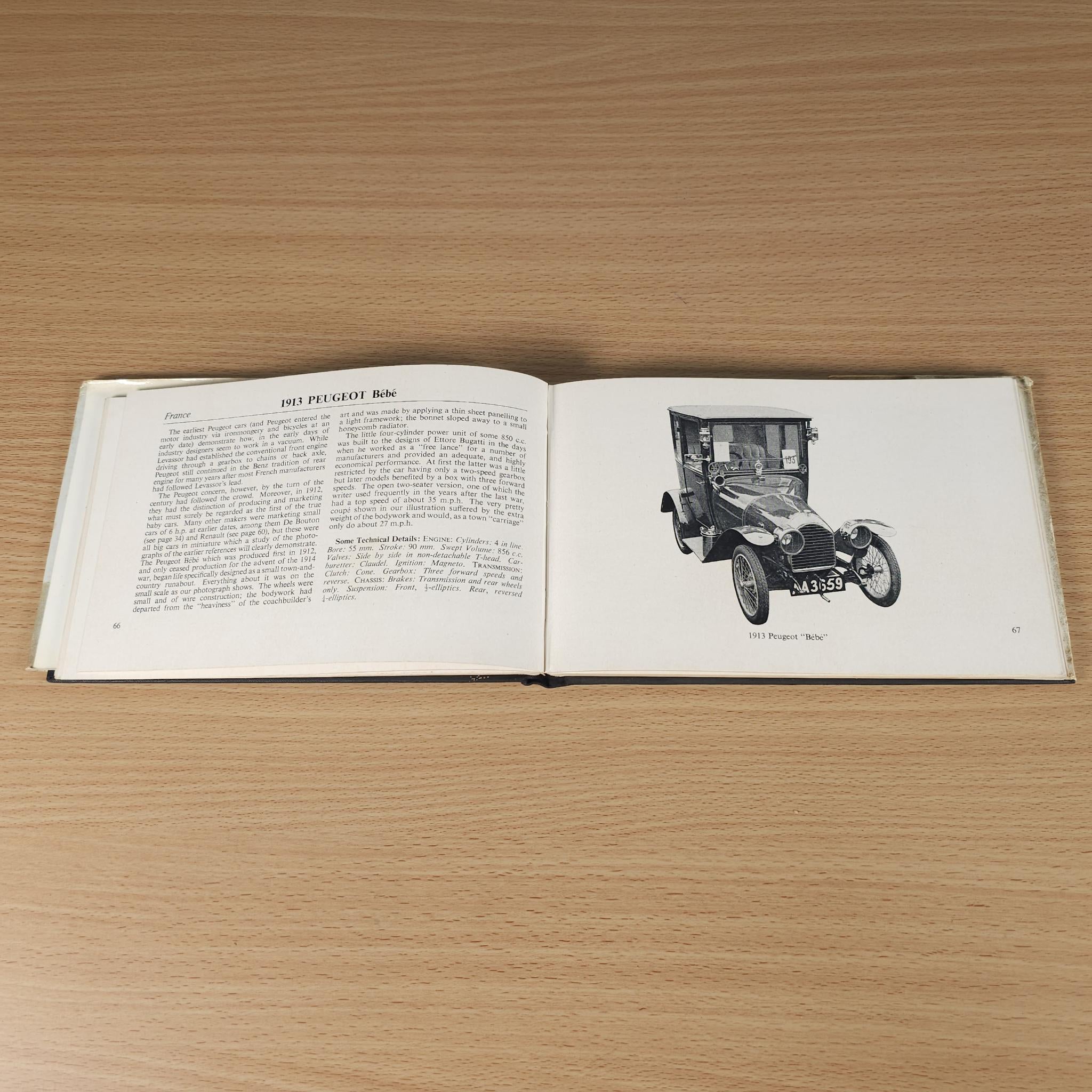 Opened vintage car book with black-and-white car photo inset on right page