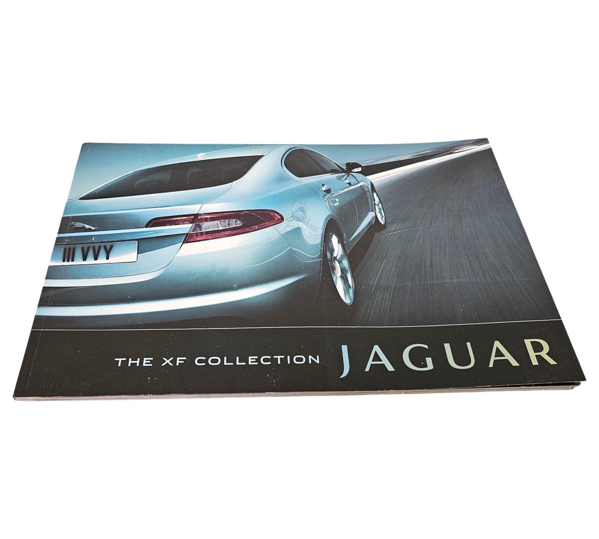Jaguar XF official portfolio book cover with blue car image and "THE XF COLLECTION JAGUAR".