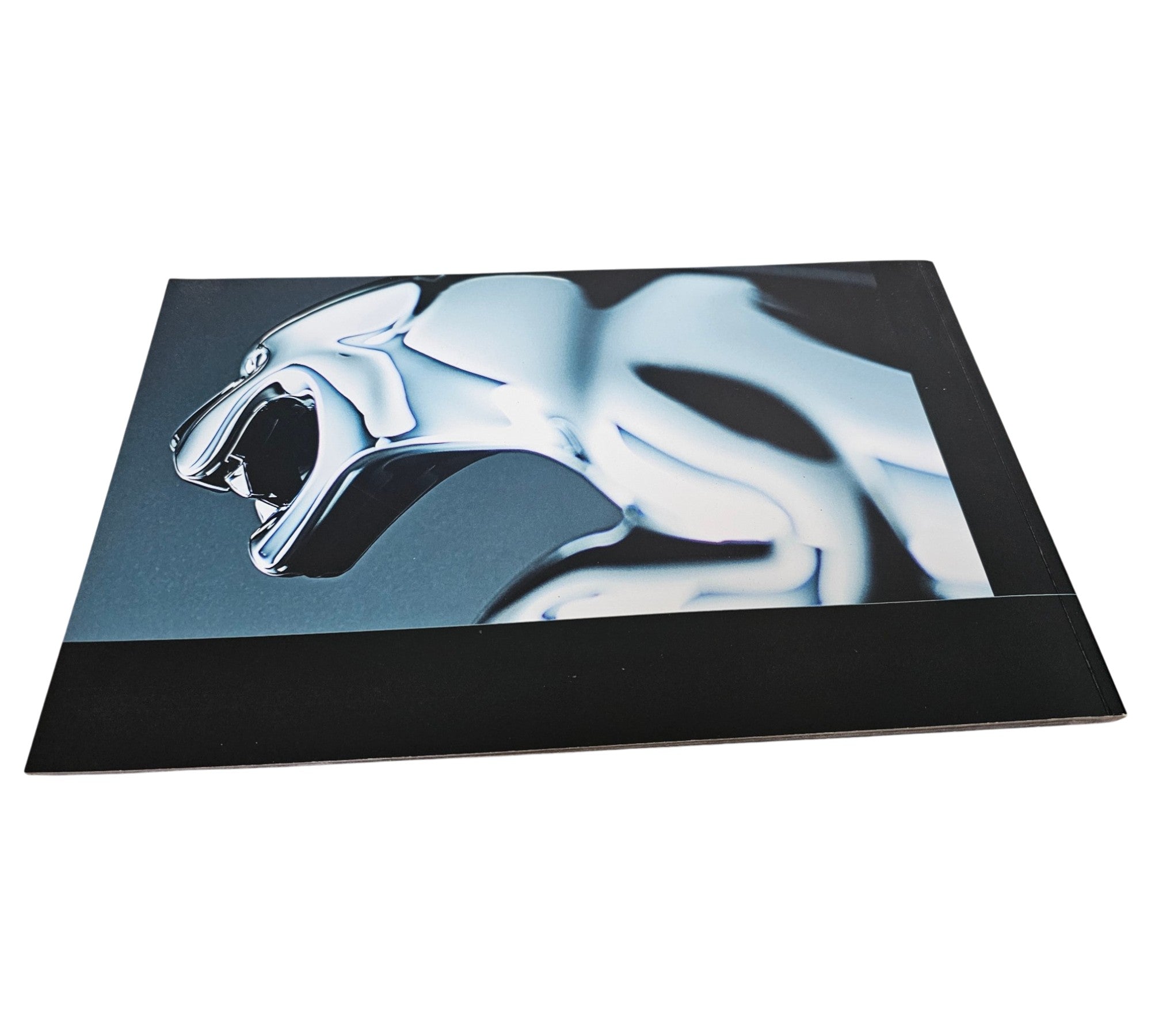 Jaguar XF official portfolio book cover with chrome car close-up graphic.