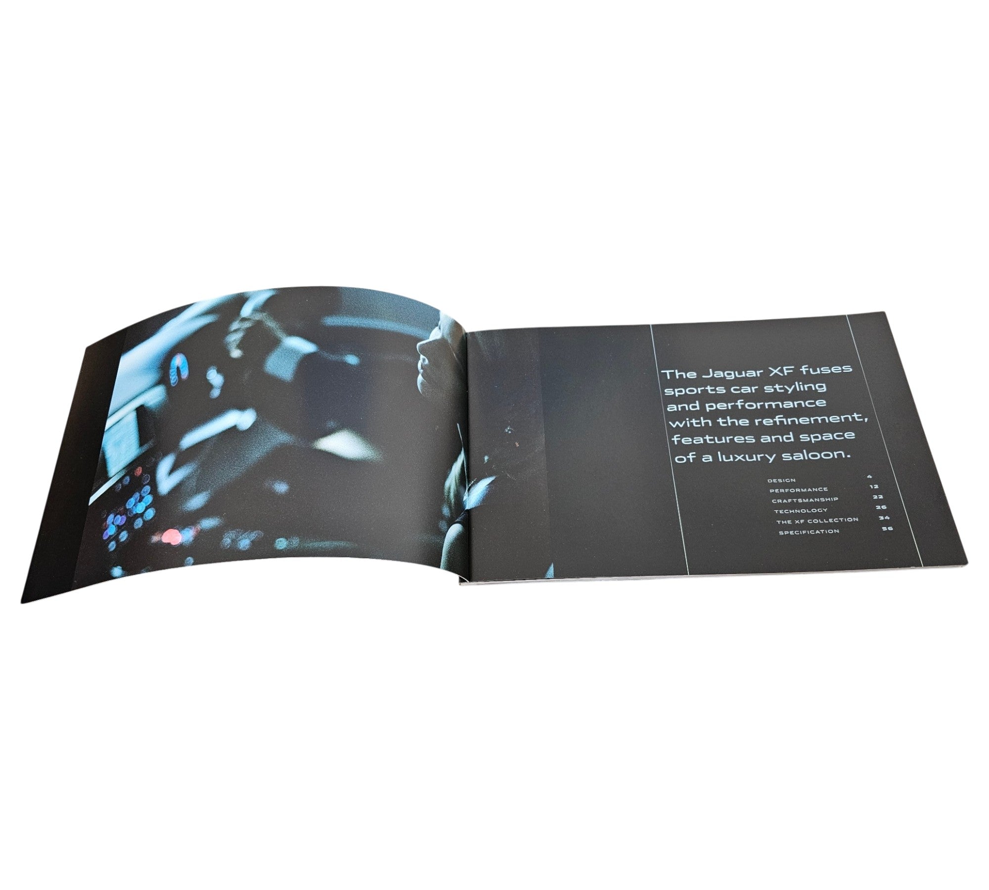 Jaguar XF official portfolio book, open spread with car photos and feature text.