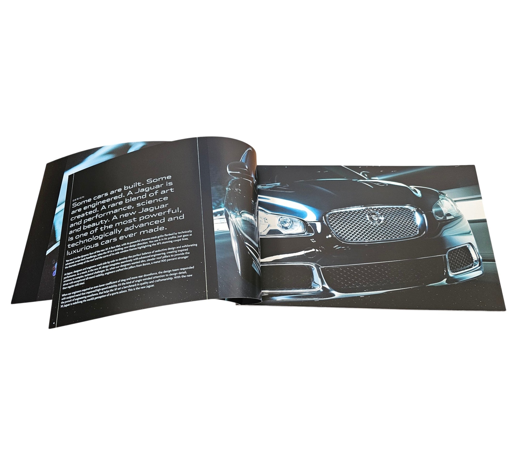 Jaguar XF official portfolio book, open spread showing front grille and headlights.