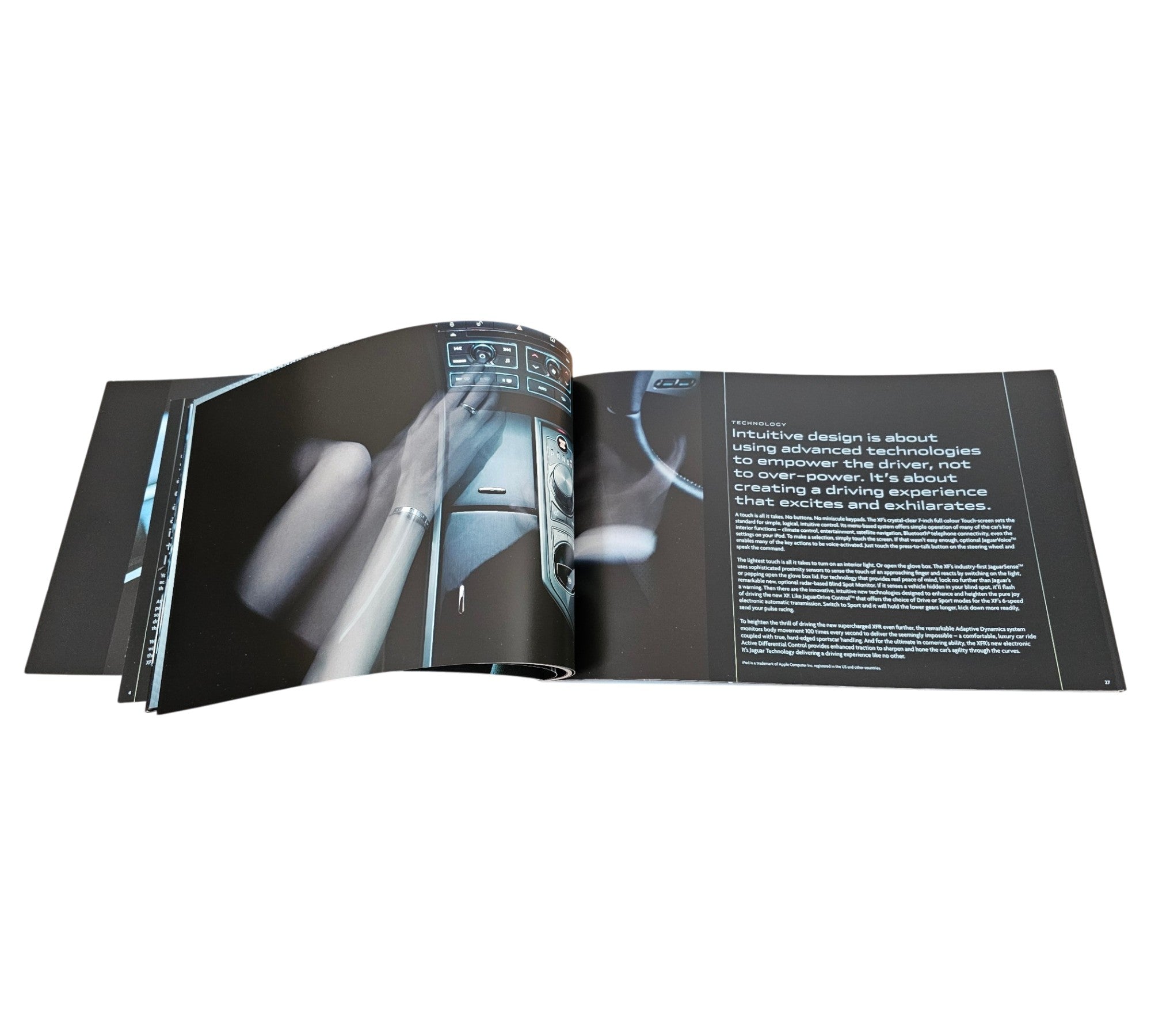 Jaguar XF official portfolio book, open spread with steering column close-up and text.
