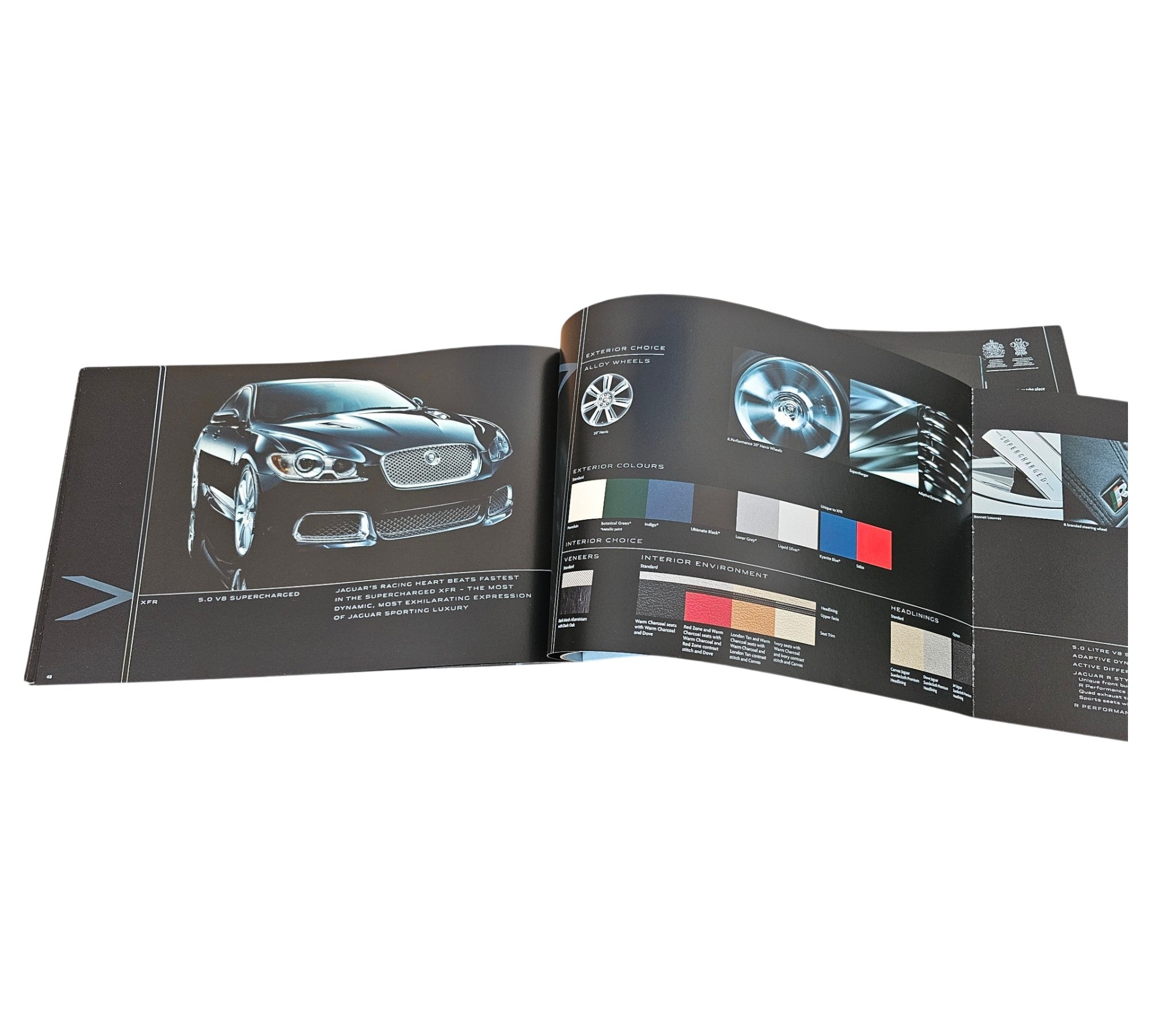 Jaguar XF official portfolio book, open spread with front car photo and color chart panel.